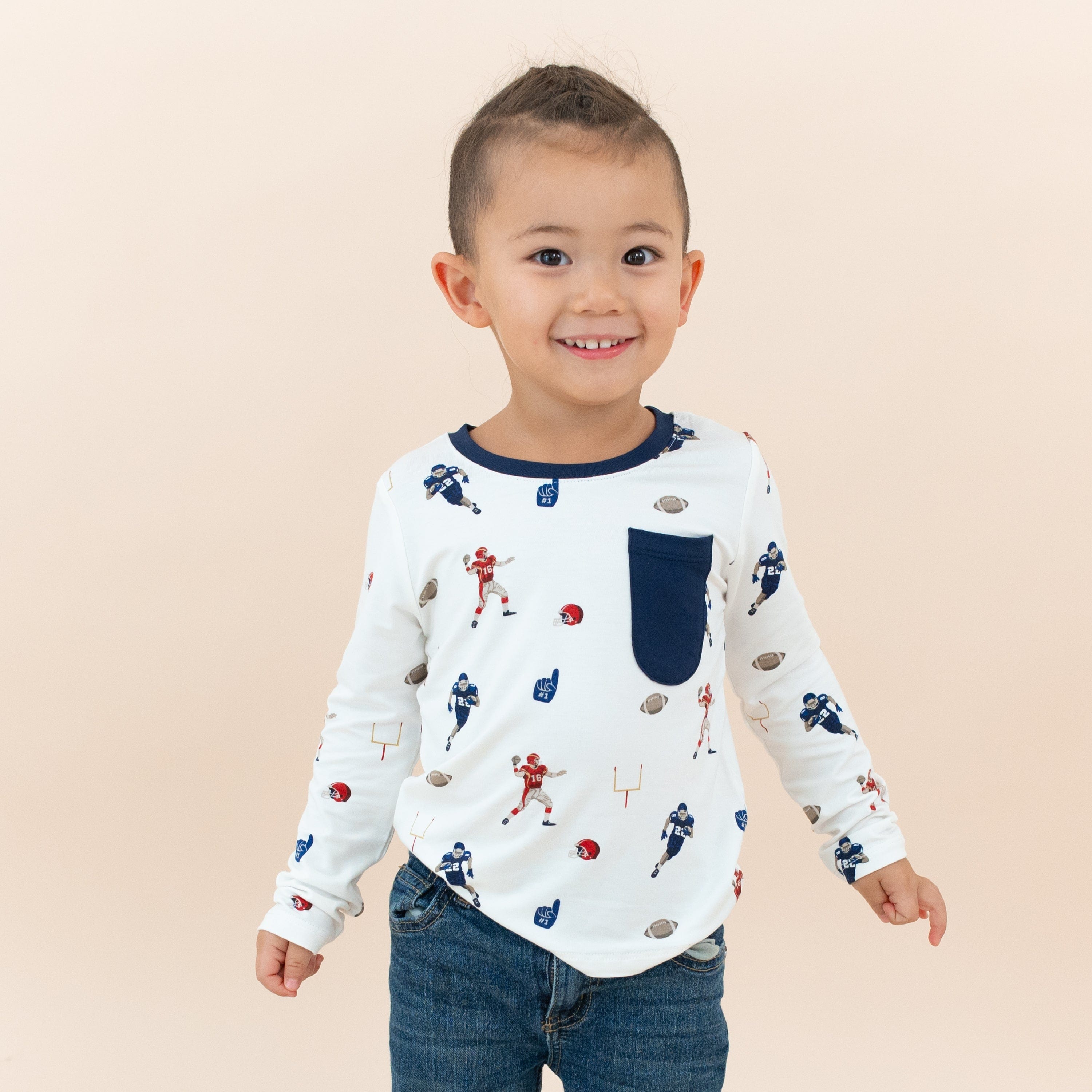 Toddler wearing Kyte Baby Long Sleeve Crew Neck Tee in Football