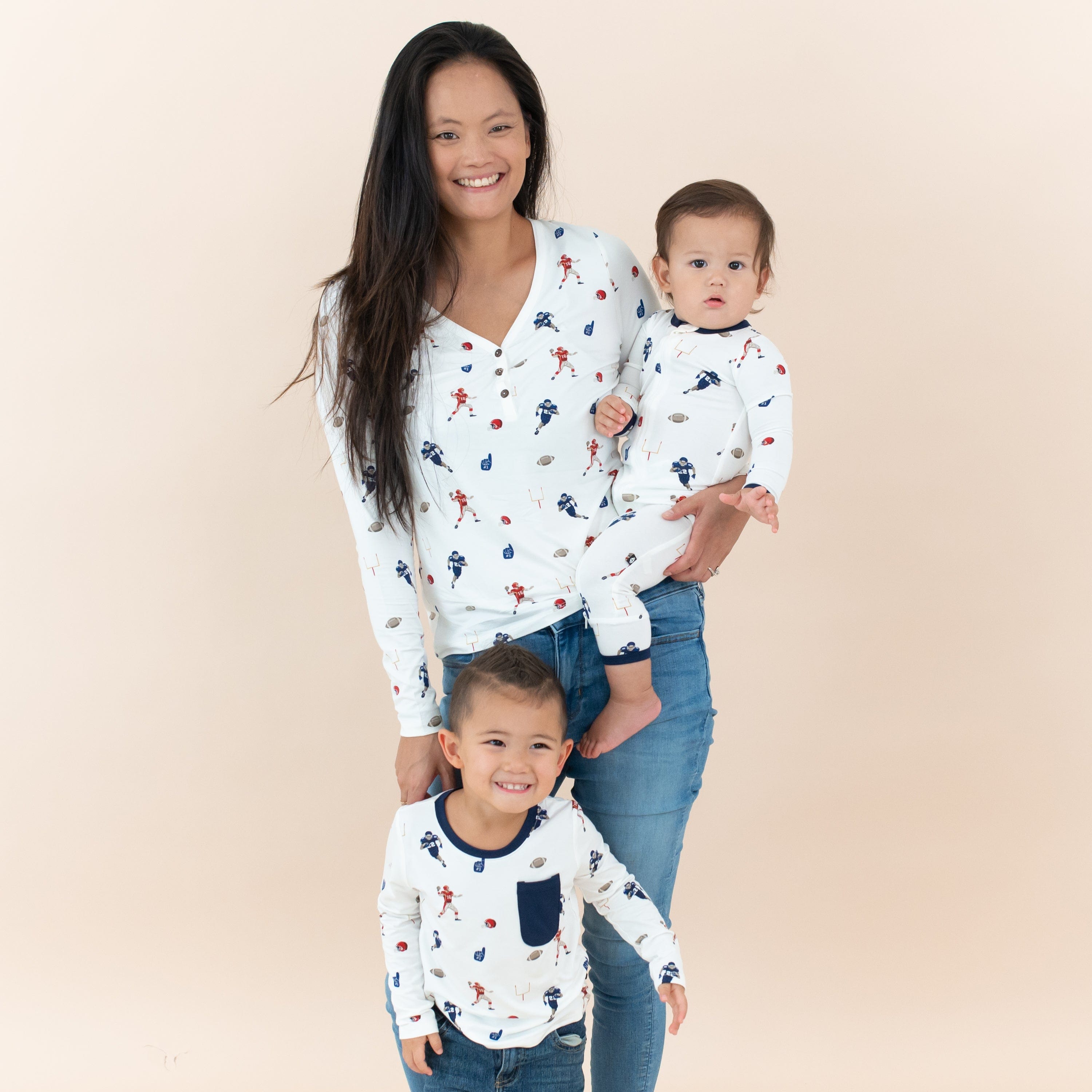 Mom with Kids wearing matching Kyte Baby outfits in Football print