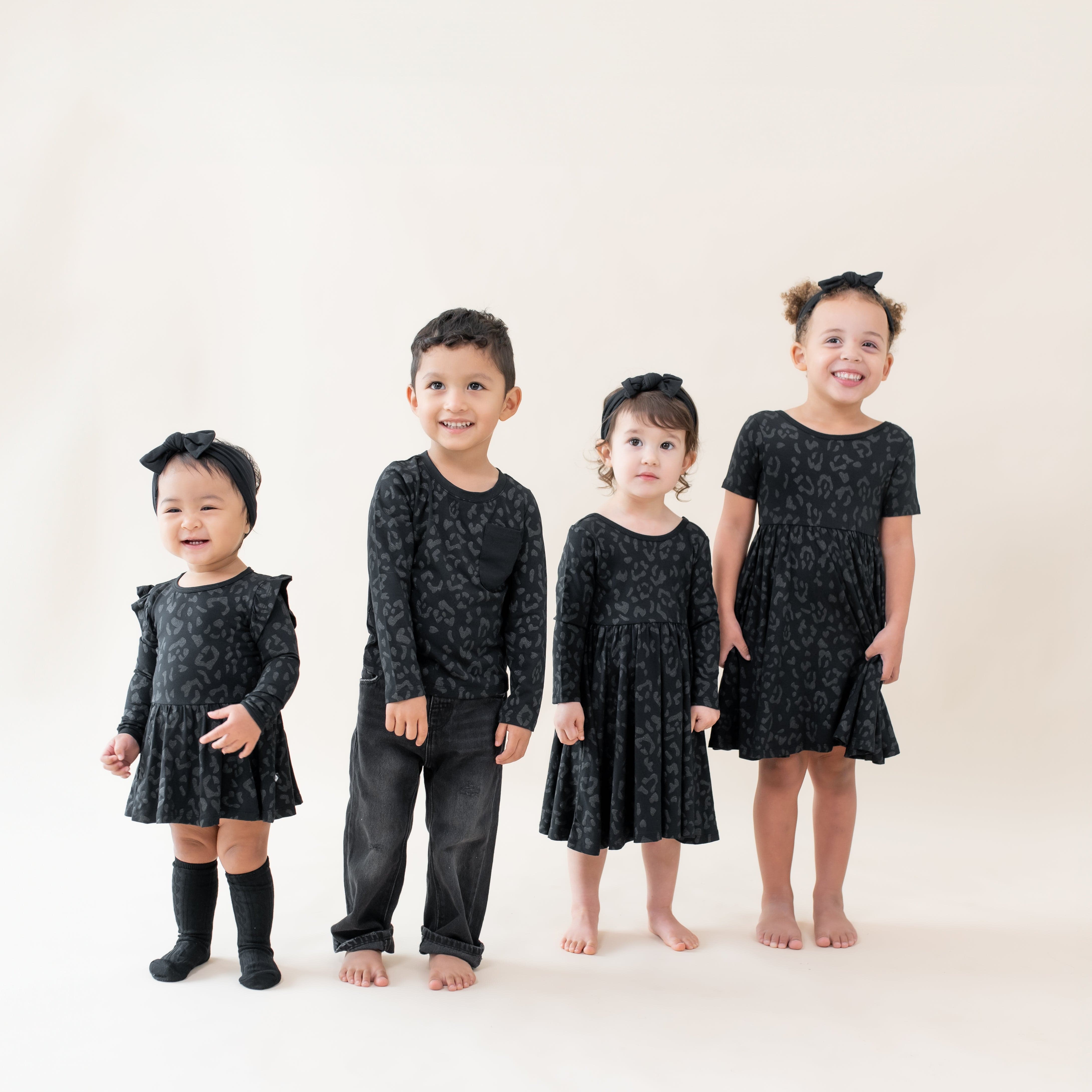 Kids wearing Kyte Baby bamboo clothing in Midnight Leopard print