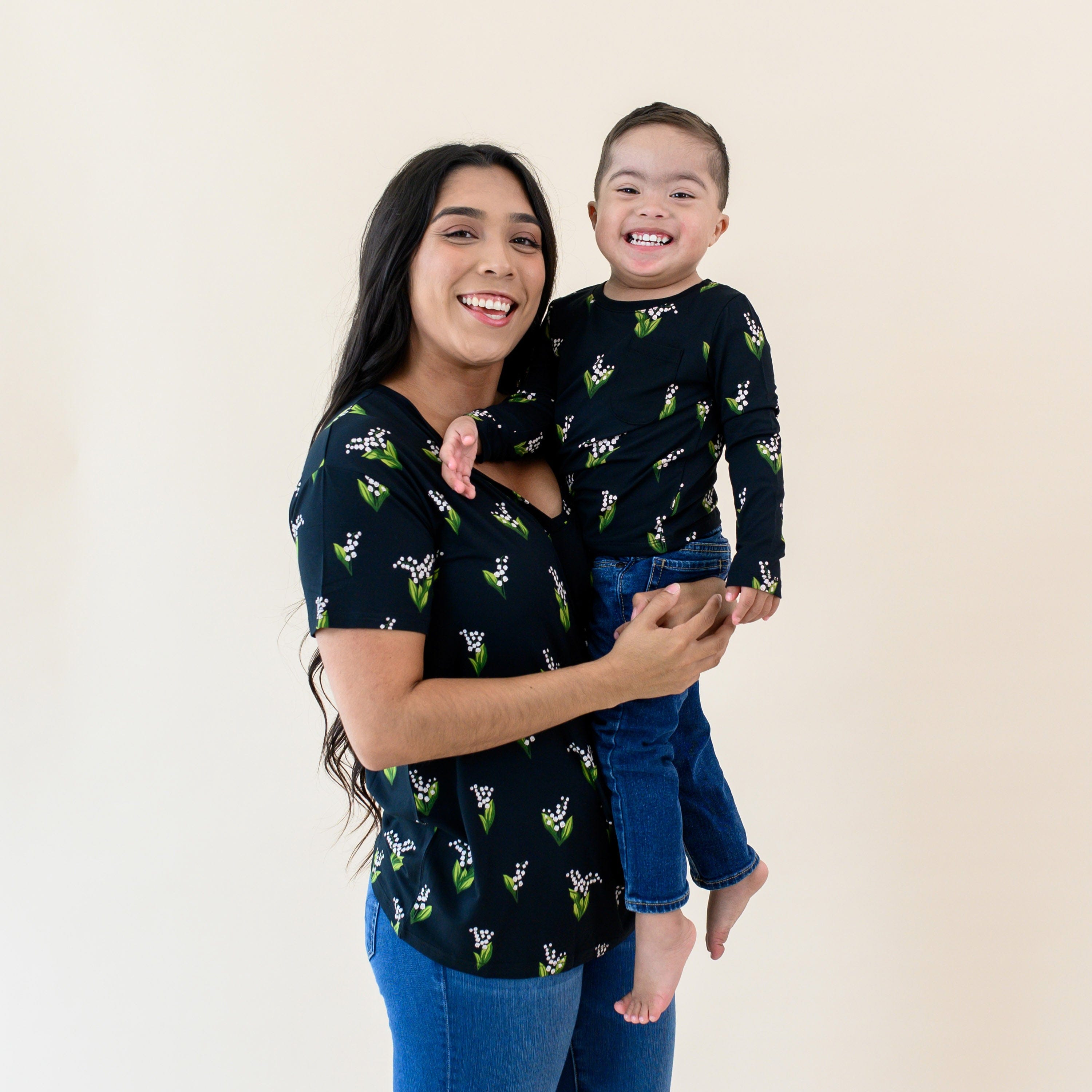 Mom in Relaxed Fit V-Neck holding Child wearing Kyte Baby Long Sleeve Crew Neck Tee in Midnight Lily