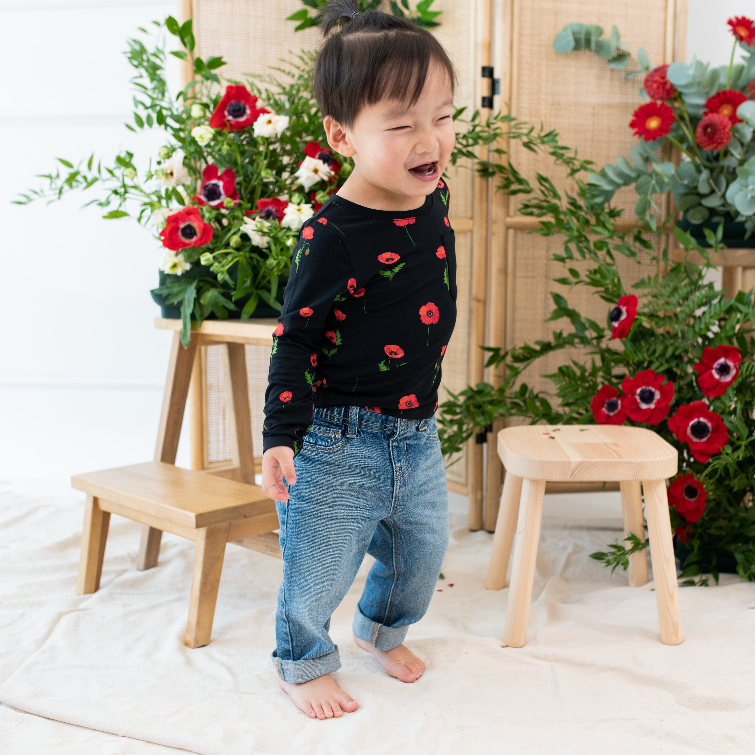 Toddler wearing Kyte Baby Long Sleeve Crew Neck Tee in Midnight Poppies