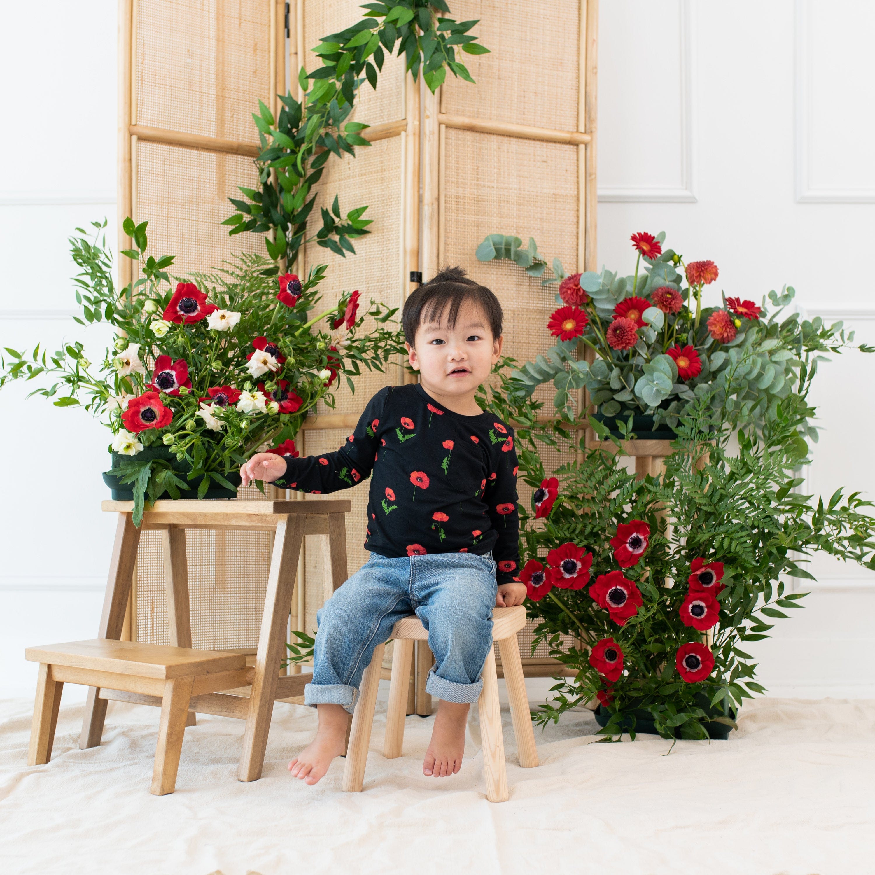 Toddler wearing Kyte Baby Long Sleeve Crew Neck Tee with pocket in Midnight Poppies
