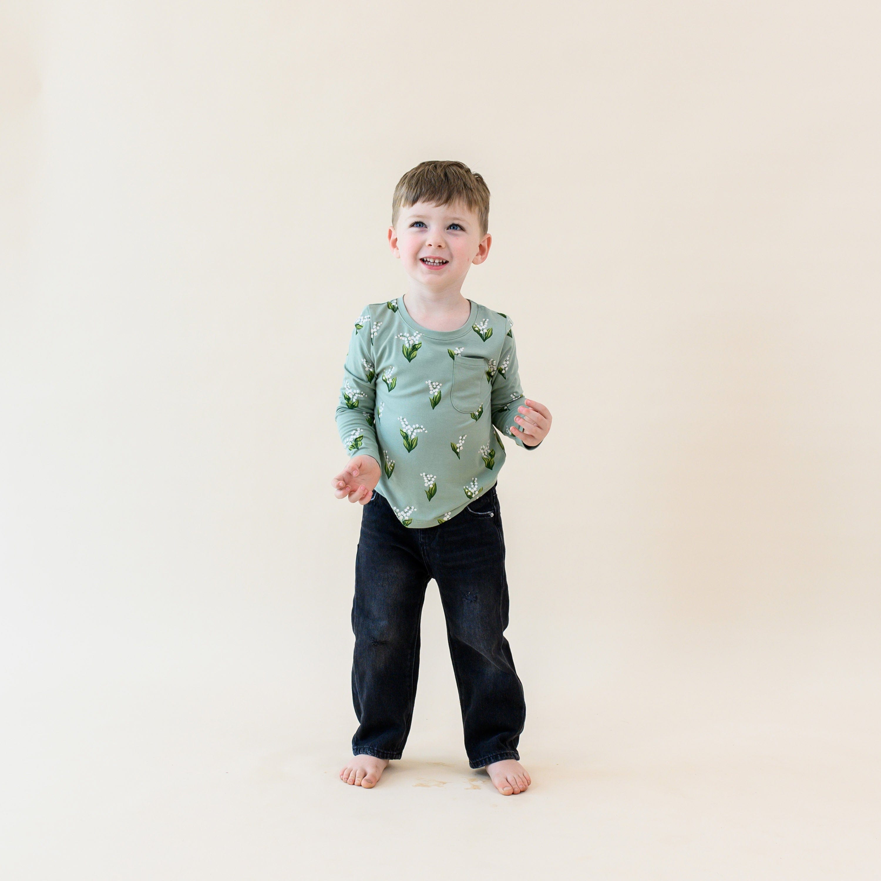 Toddler wearing Kyte Baby Unisex Long Sleeve Crew Neck Tee in Thyme Lily