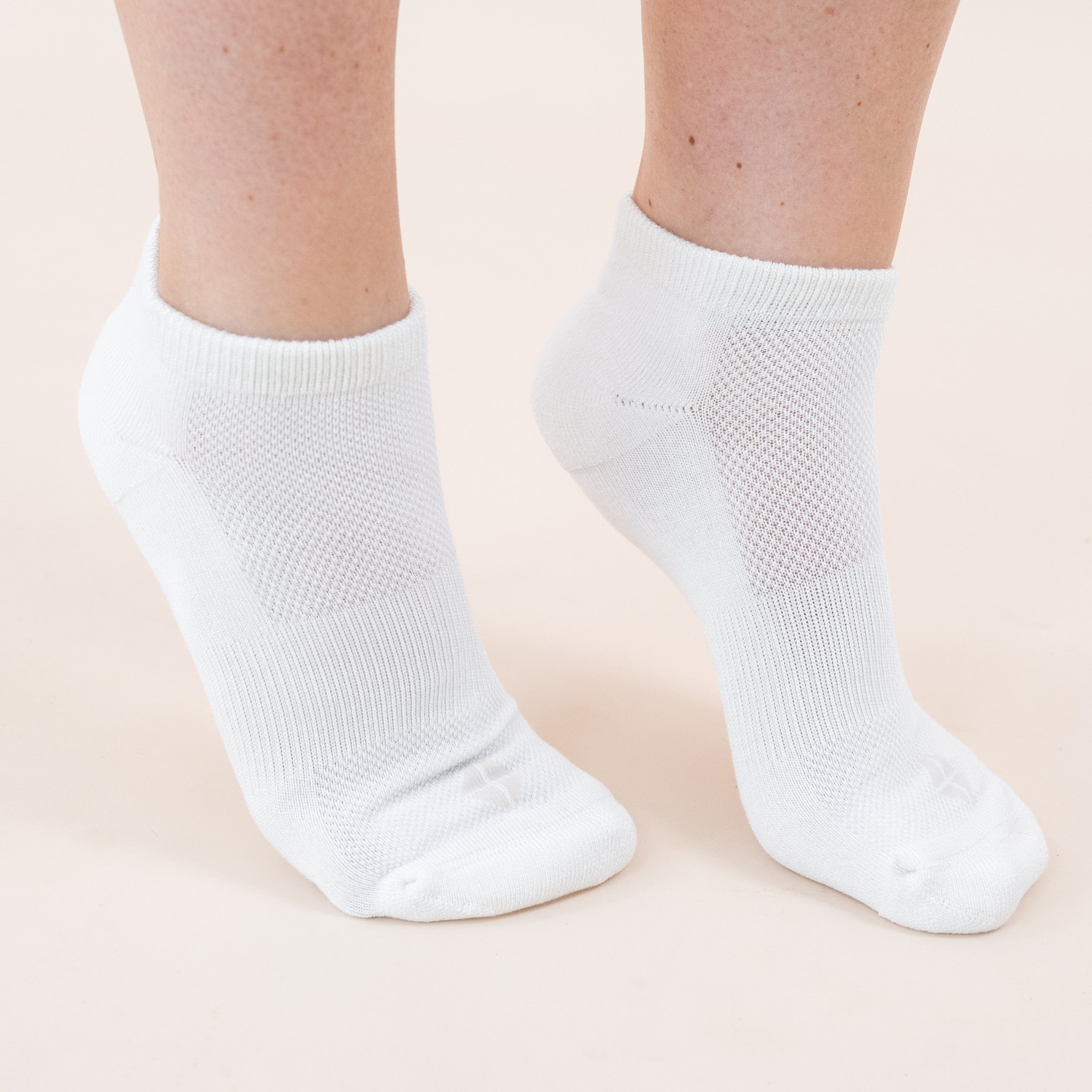 Woman wearing pair of Kyte Baby Women's Ankle Socks in Cloud white