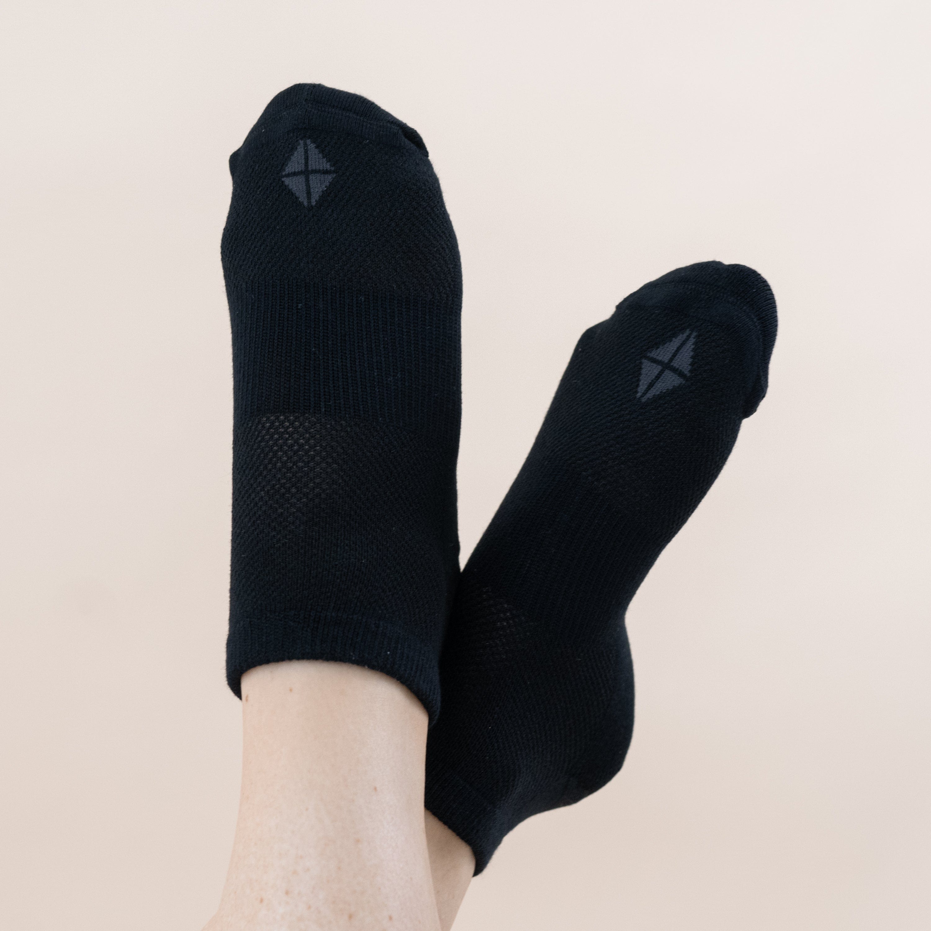 Woman wearing pair of Kyte Baby Women's Ankle Socks in Midnight