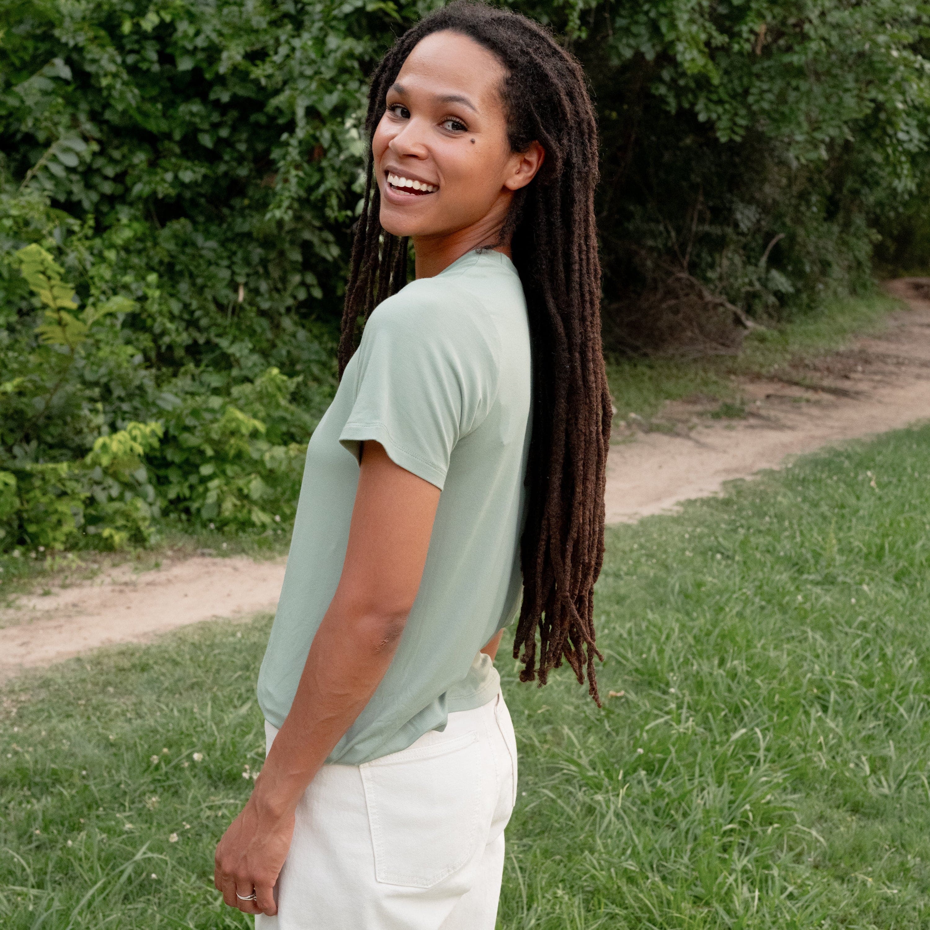 Woman wearing Kyte Baby Women's relaxed fit Crew Neck Tee in Thyme green