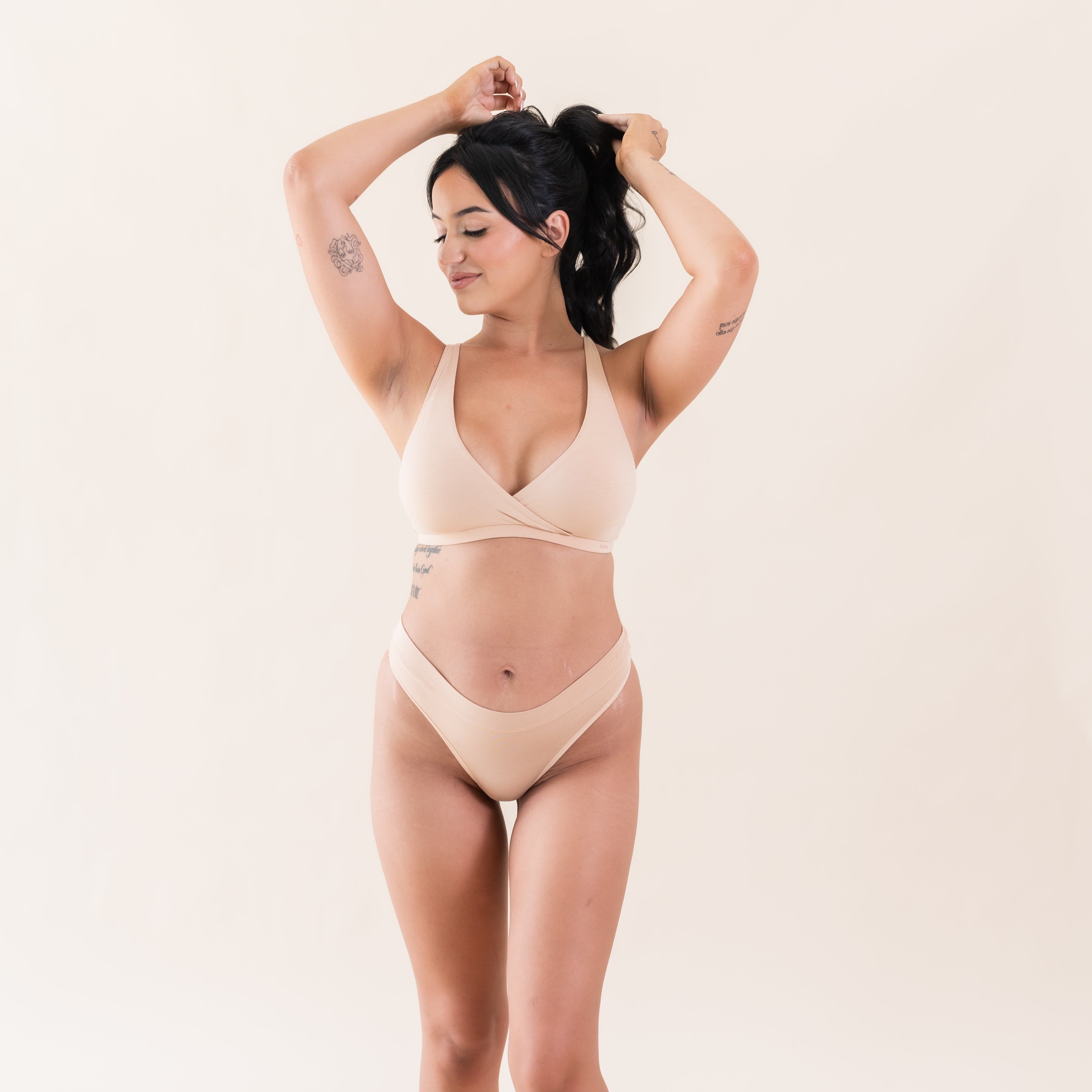 Woman wearing Kyte Baby Women's Crossover Front Bamboo Bralette in Chai