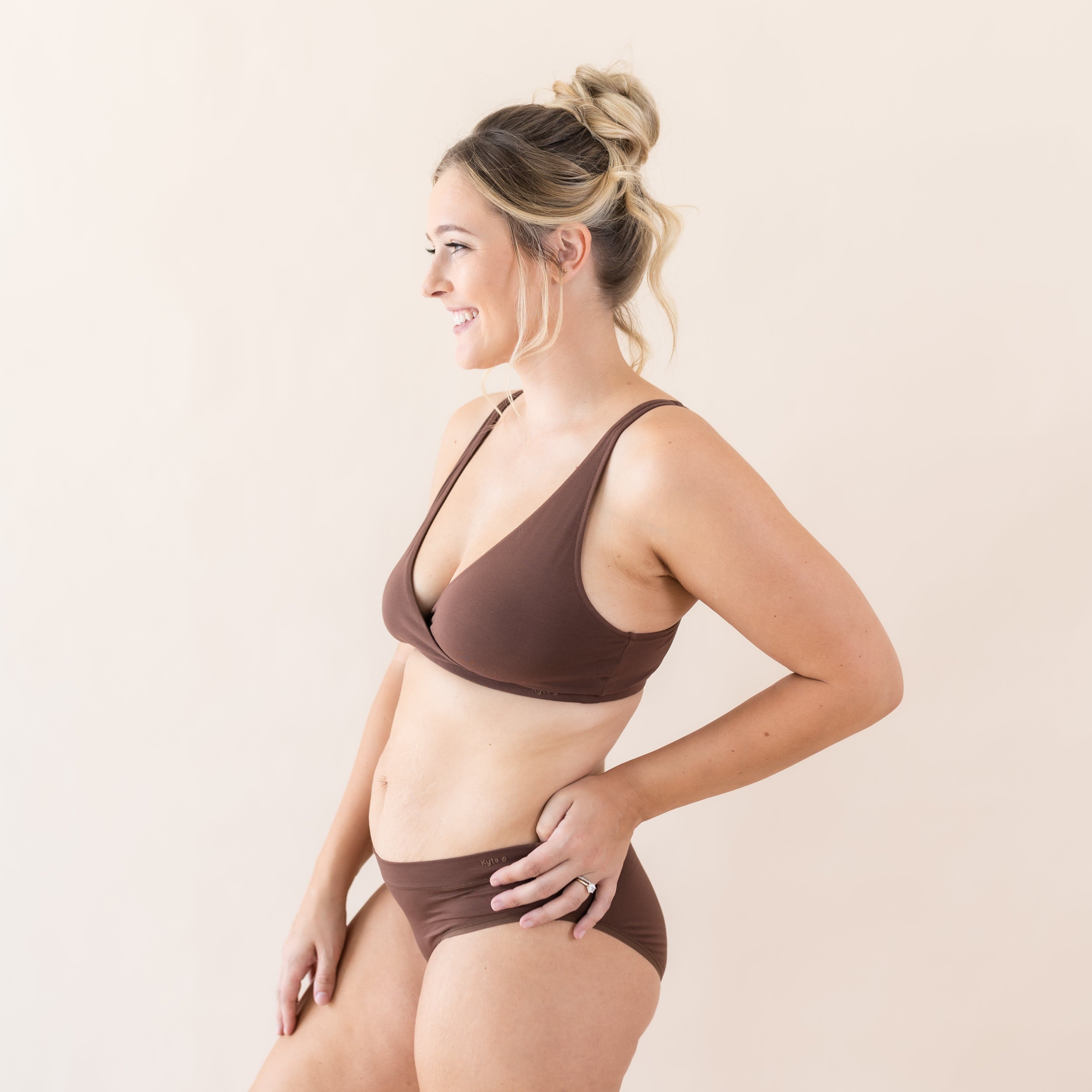 Woman wearing Kyte Baby Women's Cross Front Bralette and Matching Underwear in Toffee