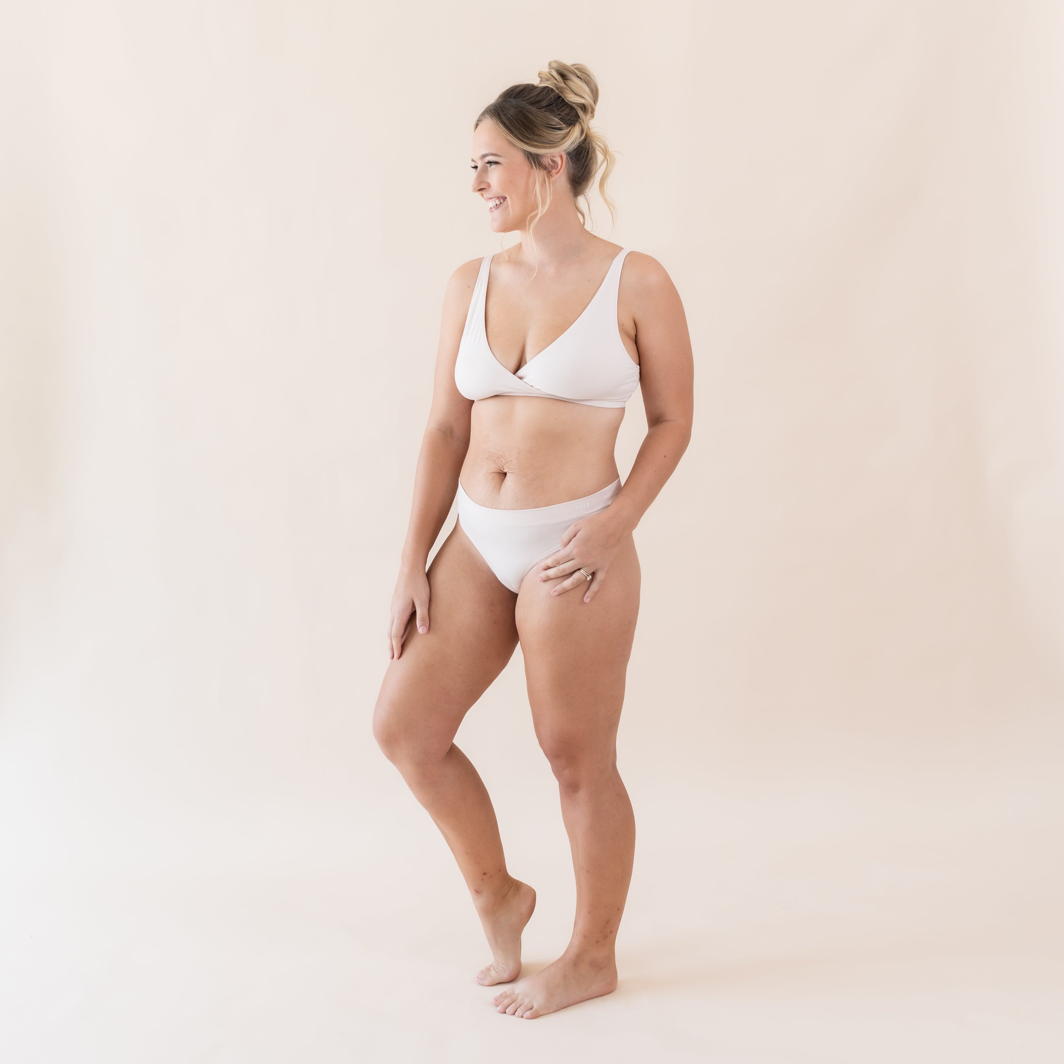 Woman wearing Kyte Baby Women's Cross Front Bralette in Blonde