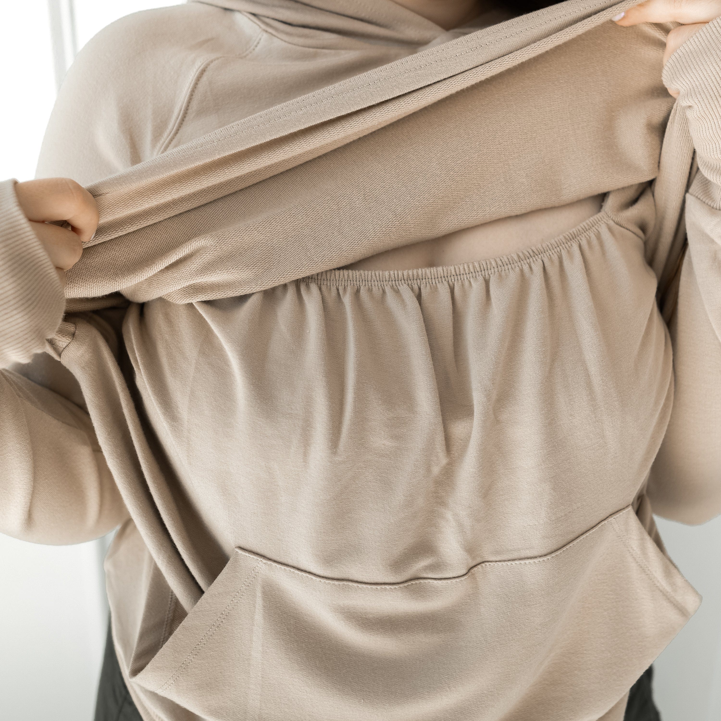 Lift up Access and Kangaroo Pocket on Kyte Baby Women's French Terry Nursing Hoodie in Almond