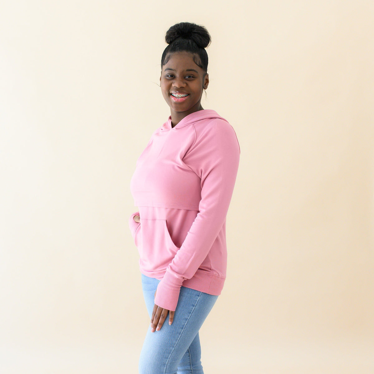 Woman wearing Kyte Baby Women's French Terry Bamboo Nursing Hoodie with Kangaroo Pocket in Apple Blossom