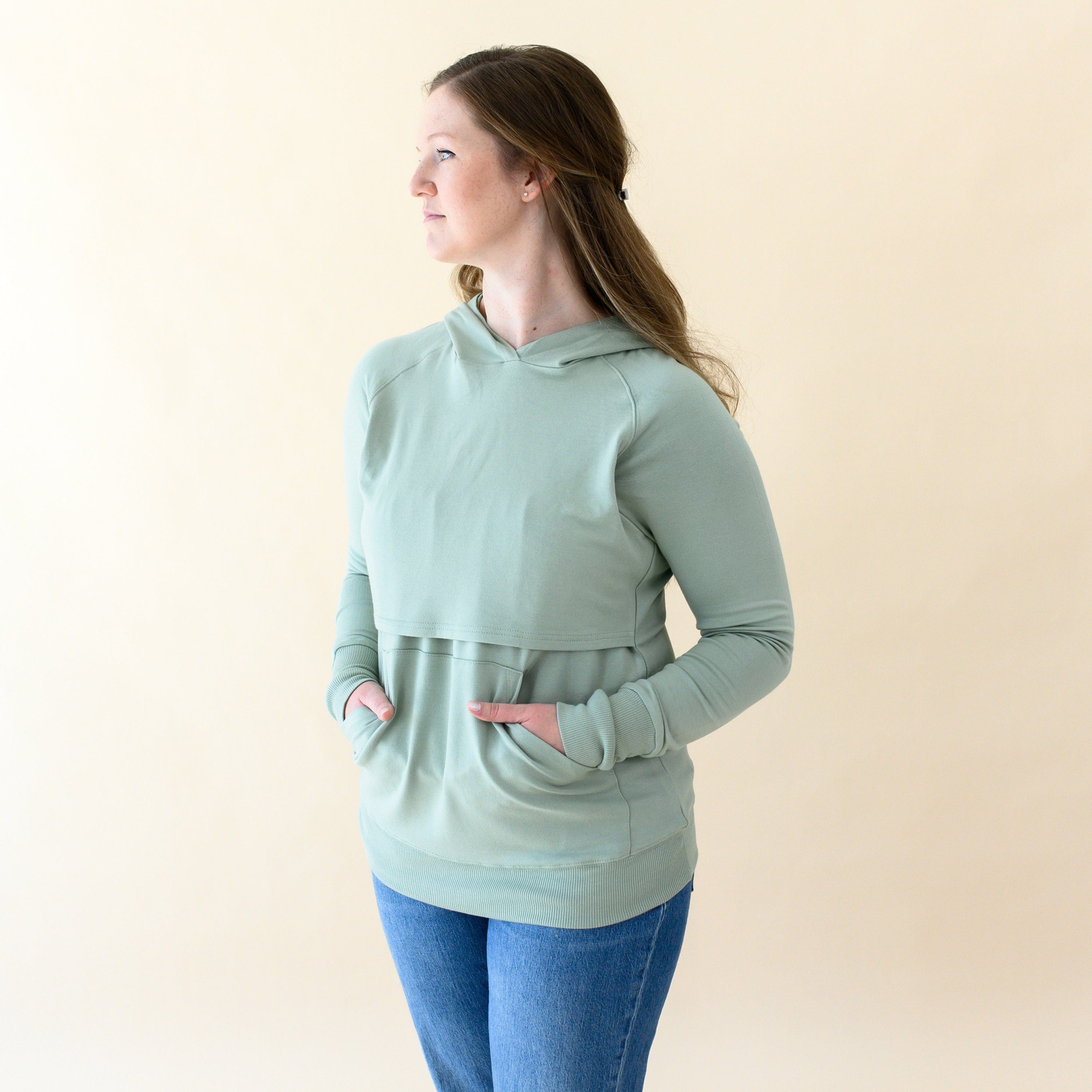 Woman wearing Kyte Baby Women's French Terry Bamboo Nursing Hoodie with Kangaroo Pocket in Thyme