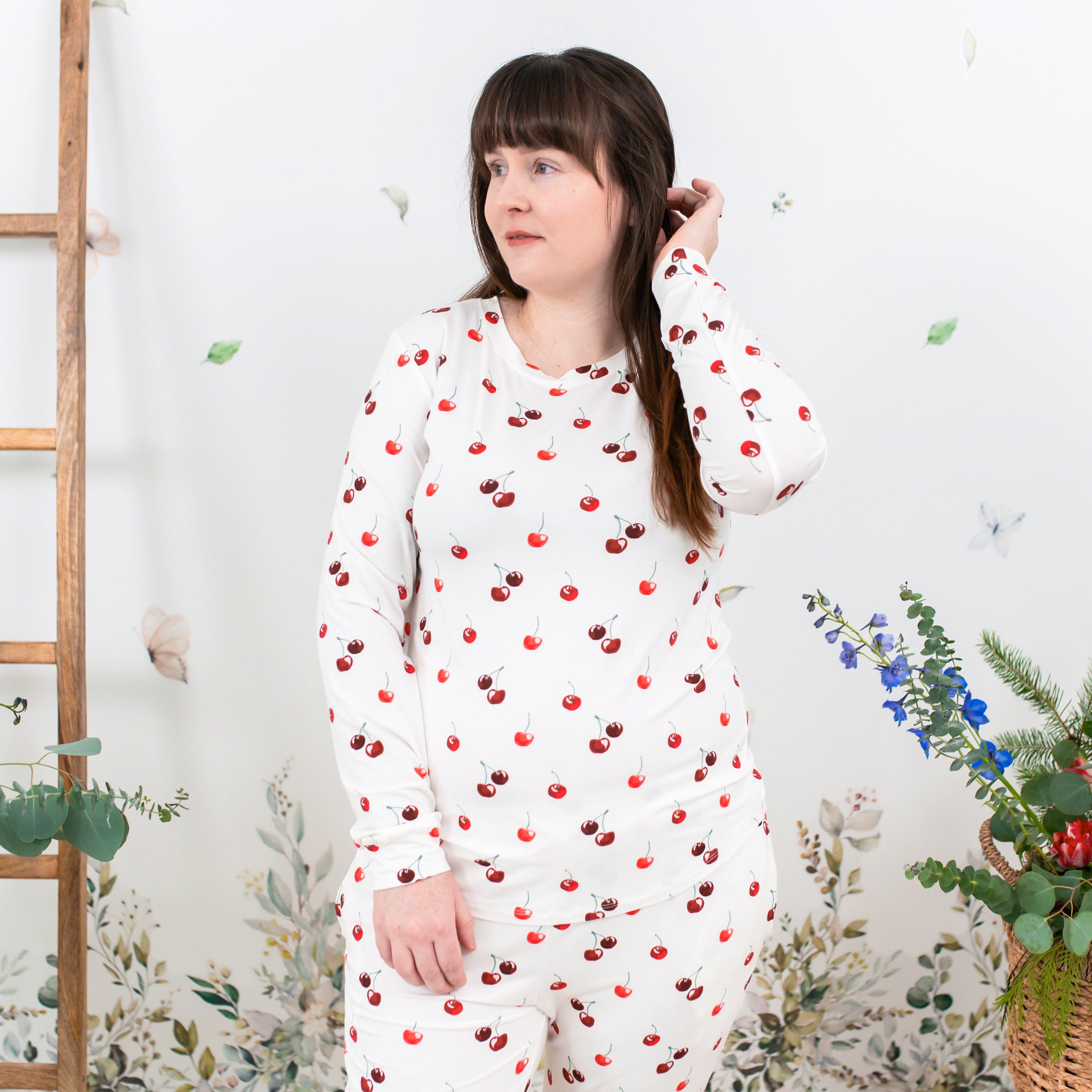 Woman wearing Kyte Baby women's jogger bamboo pajama set in Cherry