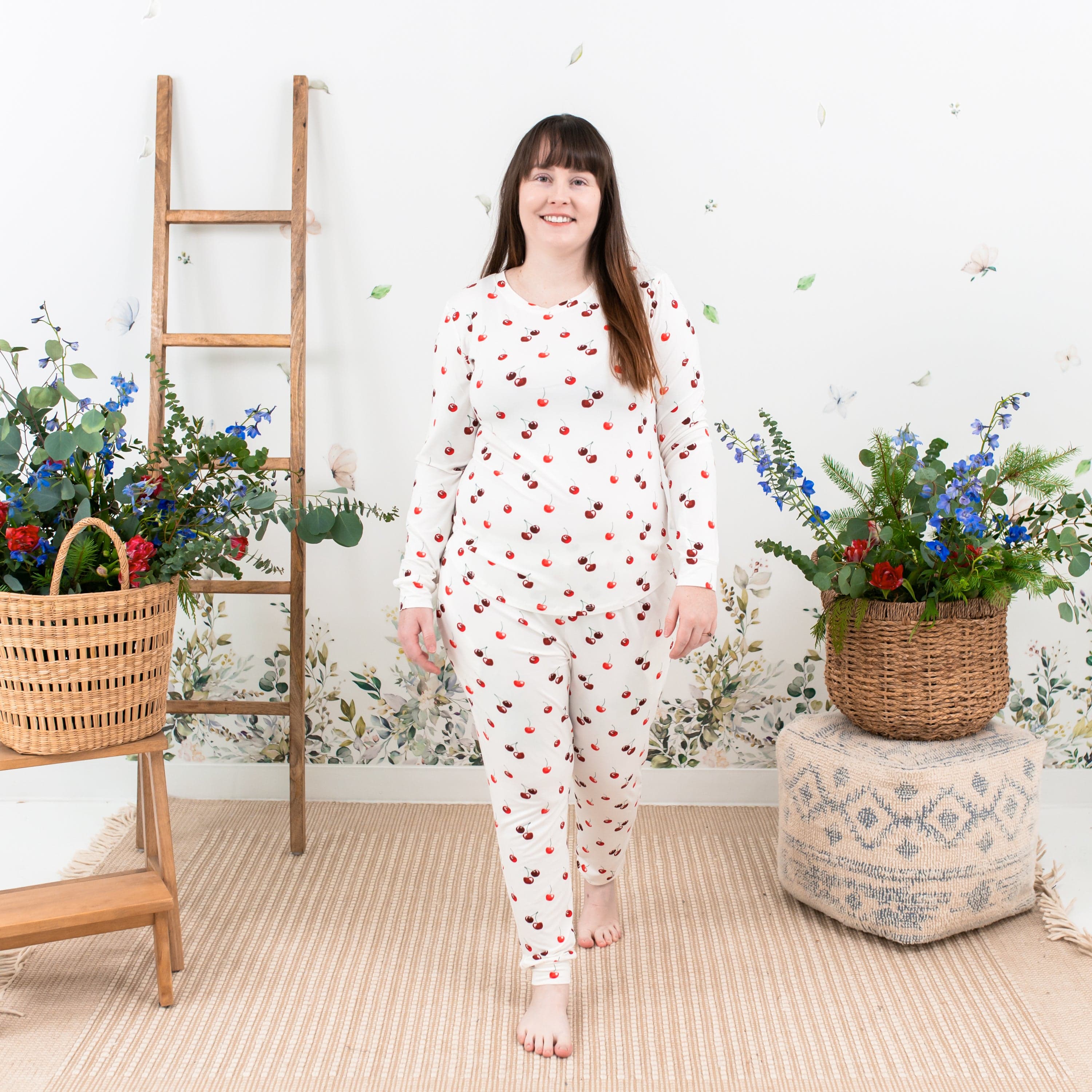 Woman wearing Kyte Baby women's jogger pajama set in Cherry