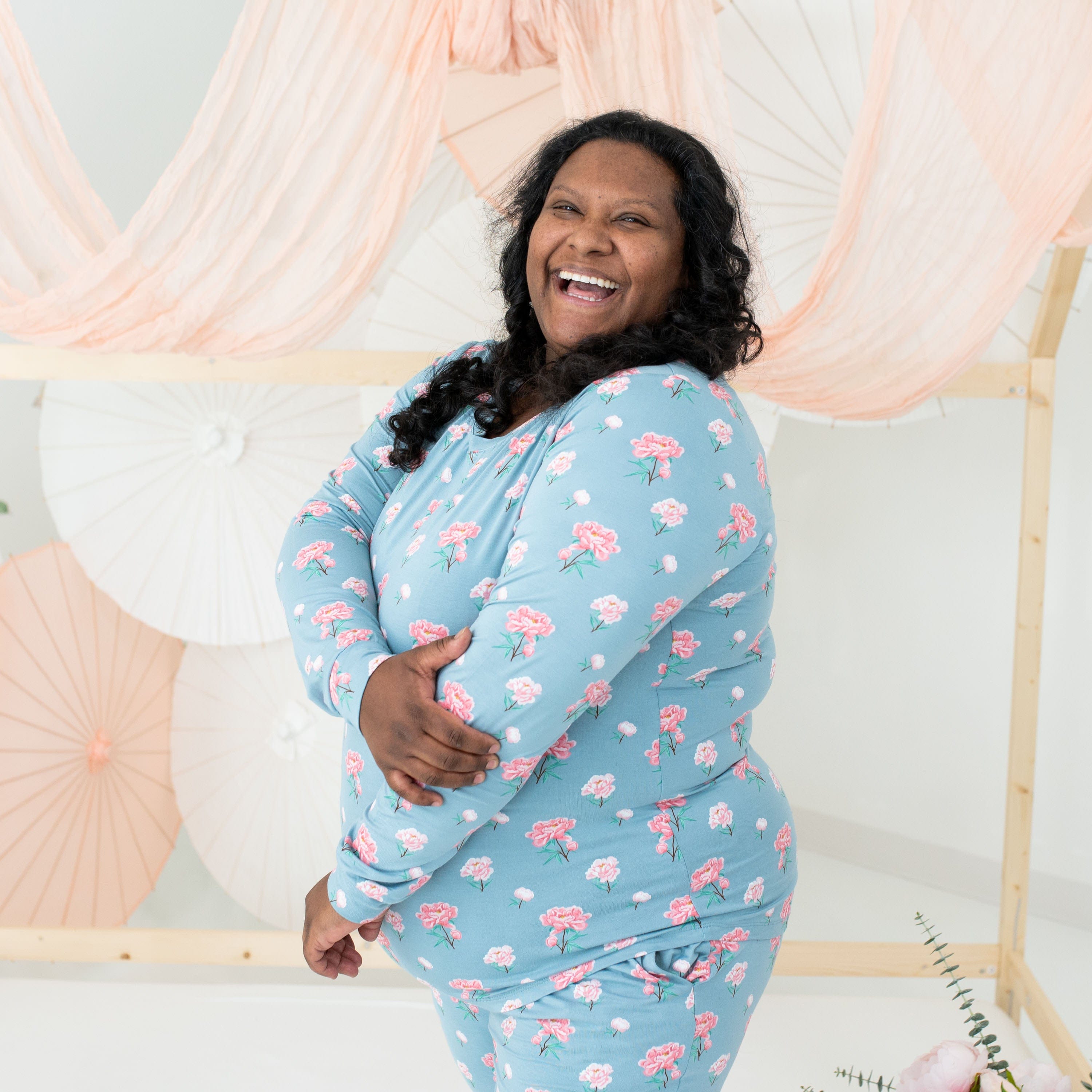 Woman wearing Kyte Baby women's jogger bamboo pajama set in Peony