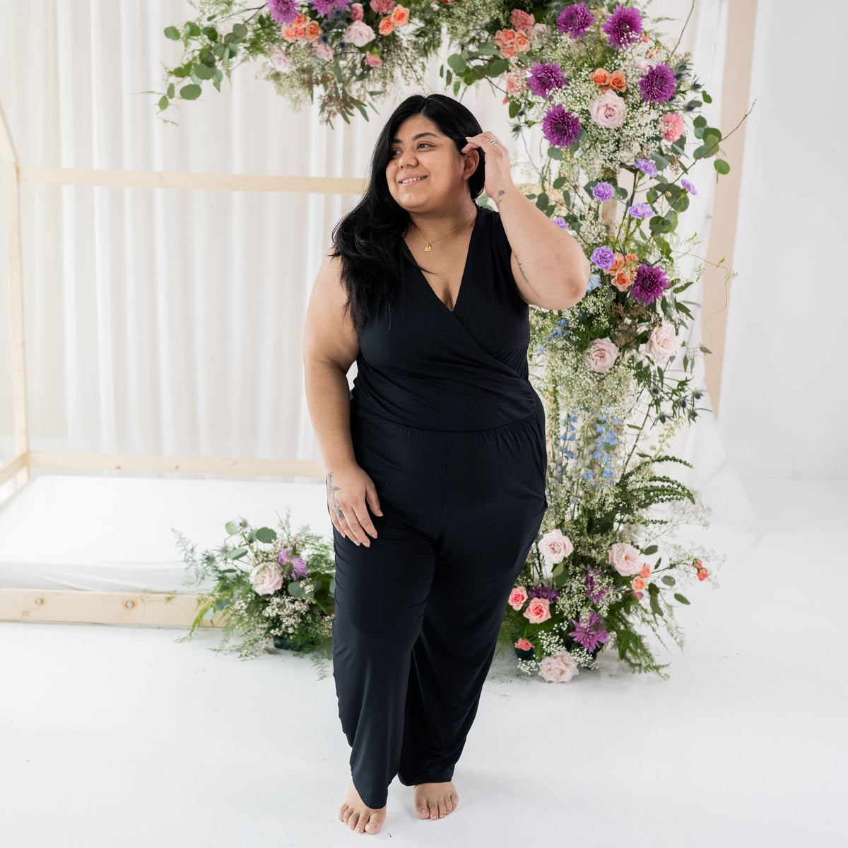 Woman wearing Kyte Baby Women's Jumpsuit with pockets in Midnight