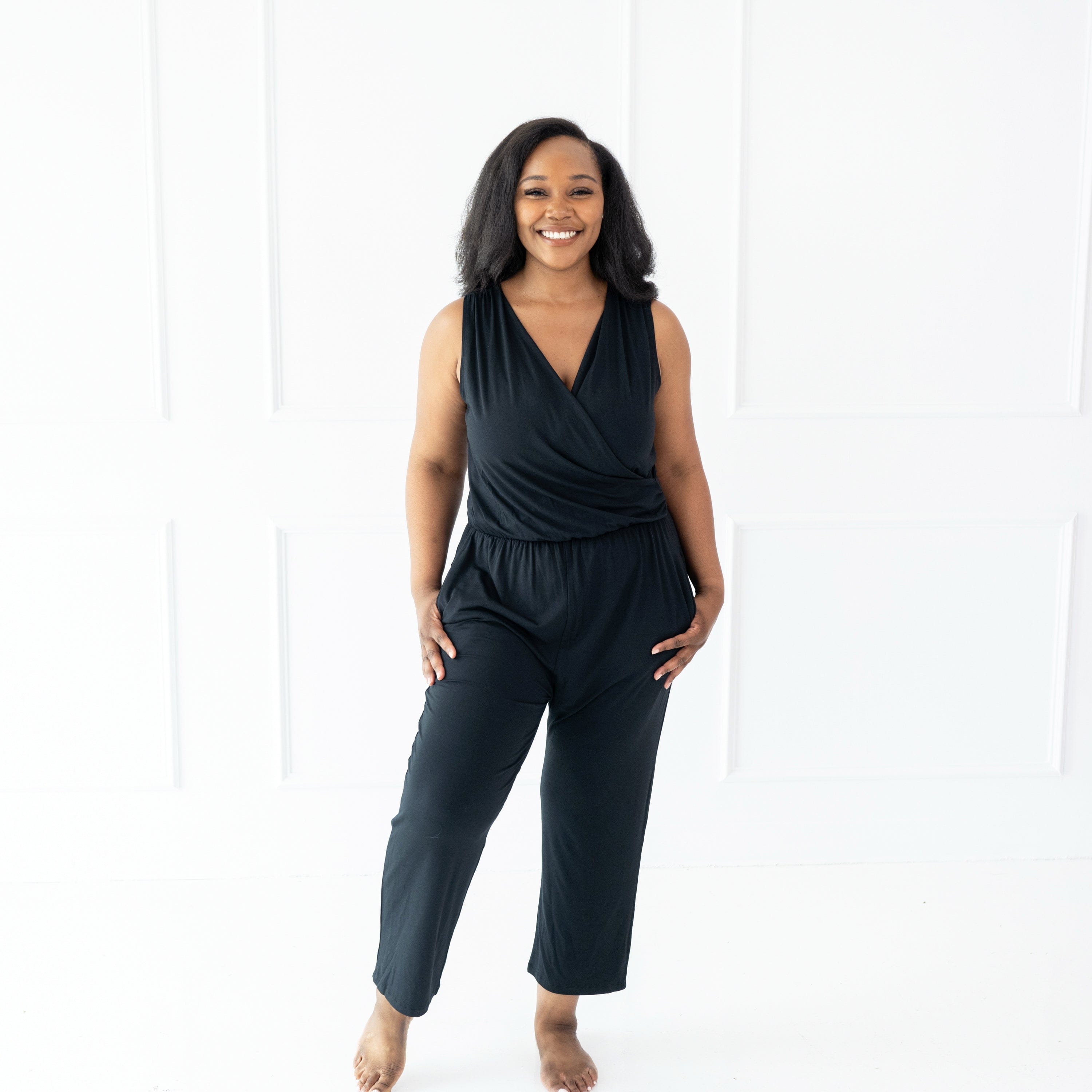 Woman wearing Kyte Baby bamboo sleeveless jumpsuit in Midnight