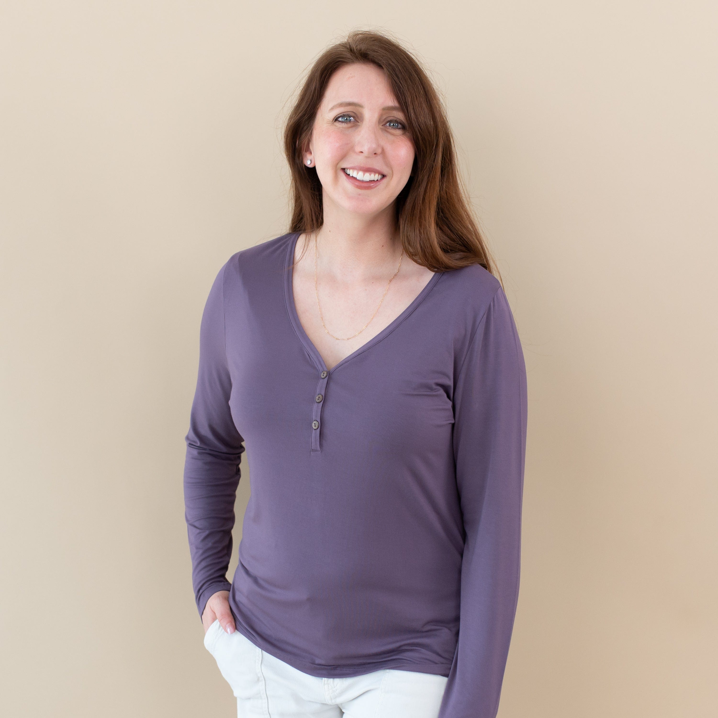 Woman wearing Kyte Baby Women's Long Sleeve Henley Tee in Currant