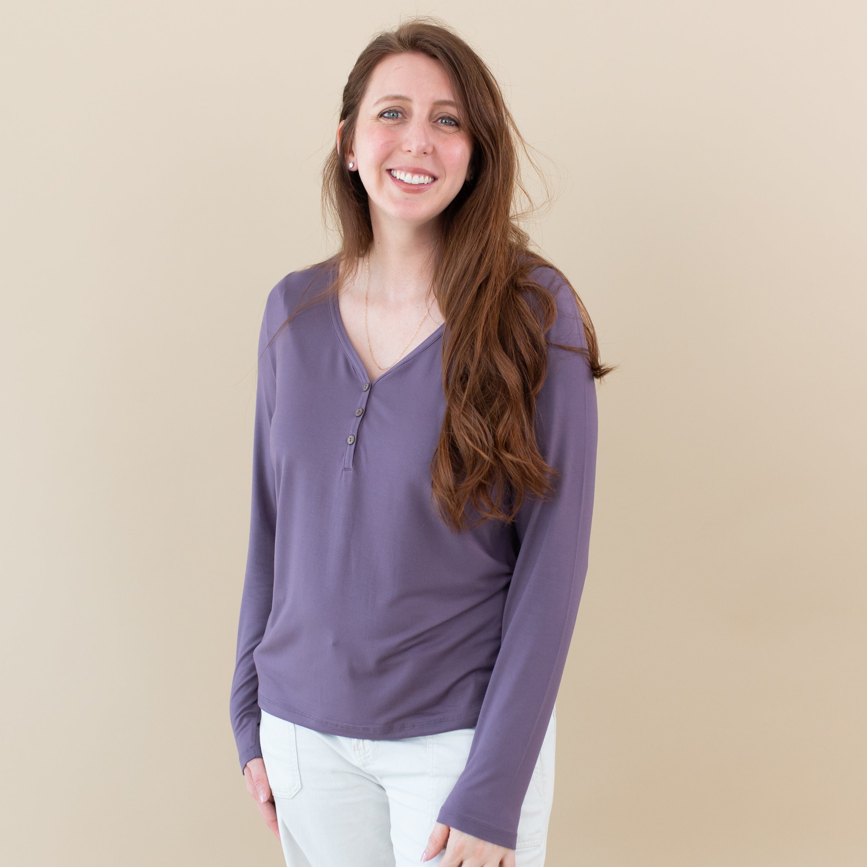 Woman wearing Kyte Baby Women's Bamboo Long Sleeve Henley Tee in Currant