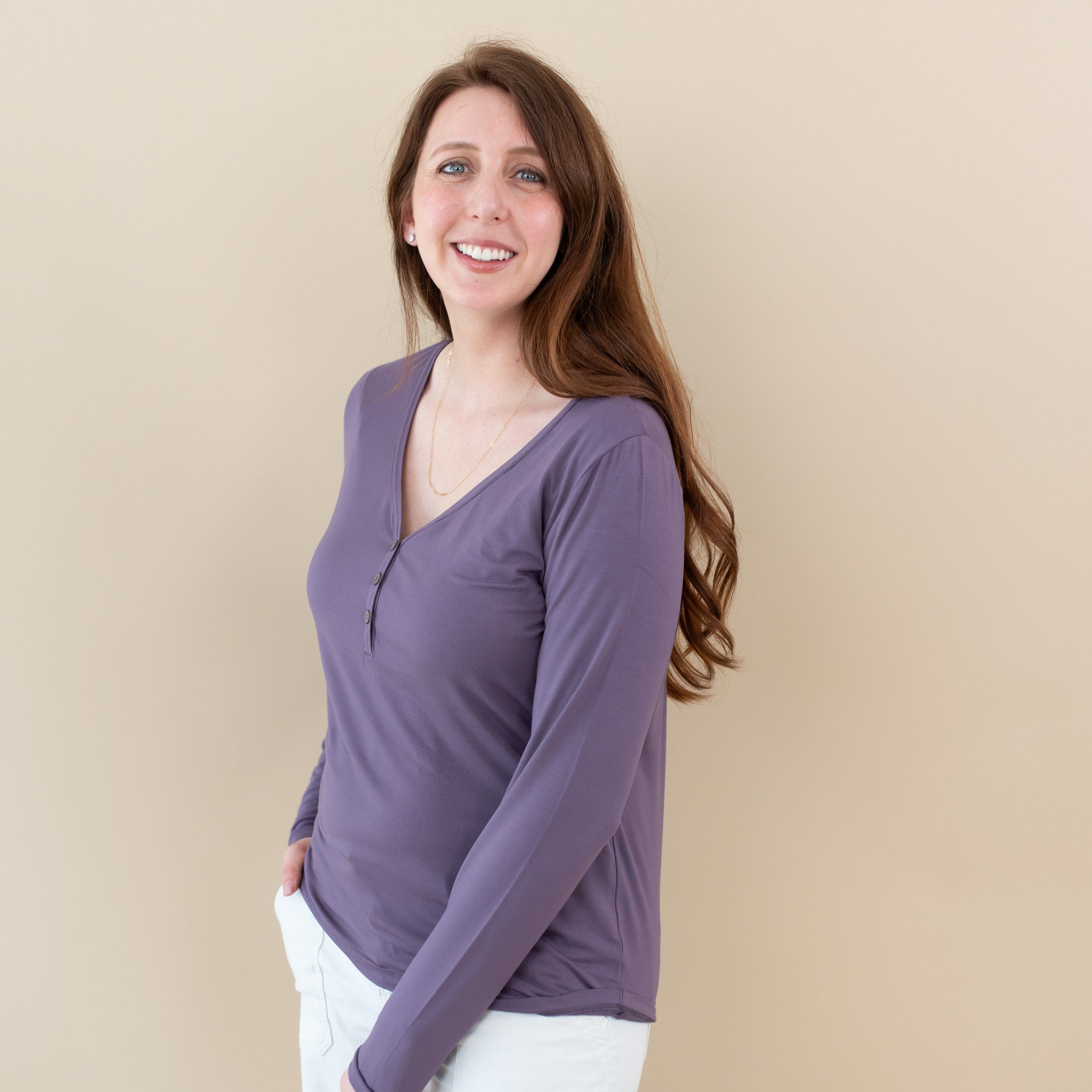 Woman wearing Kyte Baby Women's Breathable Long Sleeve Henley Tee in Currant purple