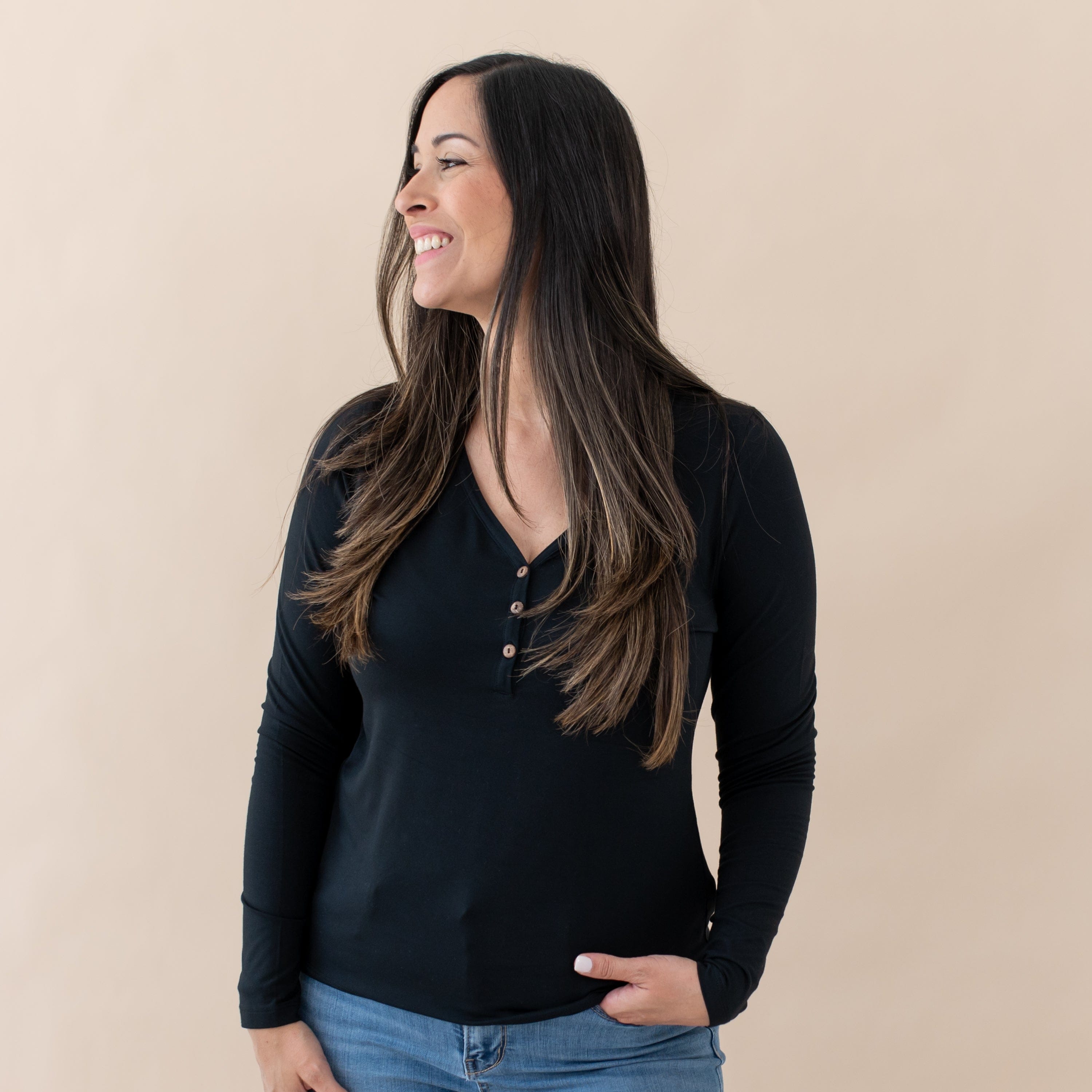 Woman wearing Kyte Baby Women's Breathable Long Sleeve Henley Tee in Midnight