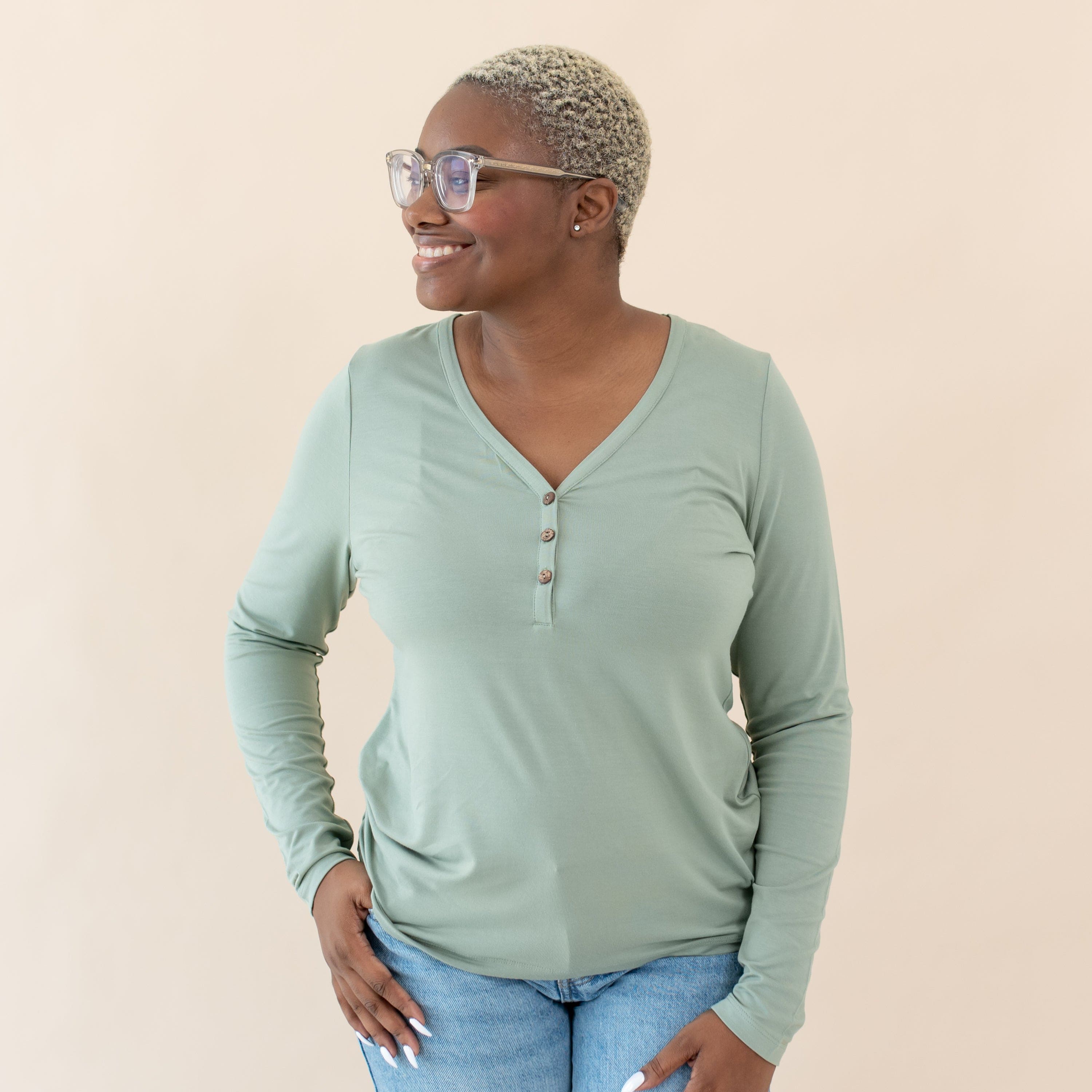 Woman wearing Kyte Baby Women's Bamboo Long Sleeve Henley Tee in Thyme green