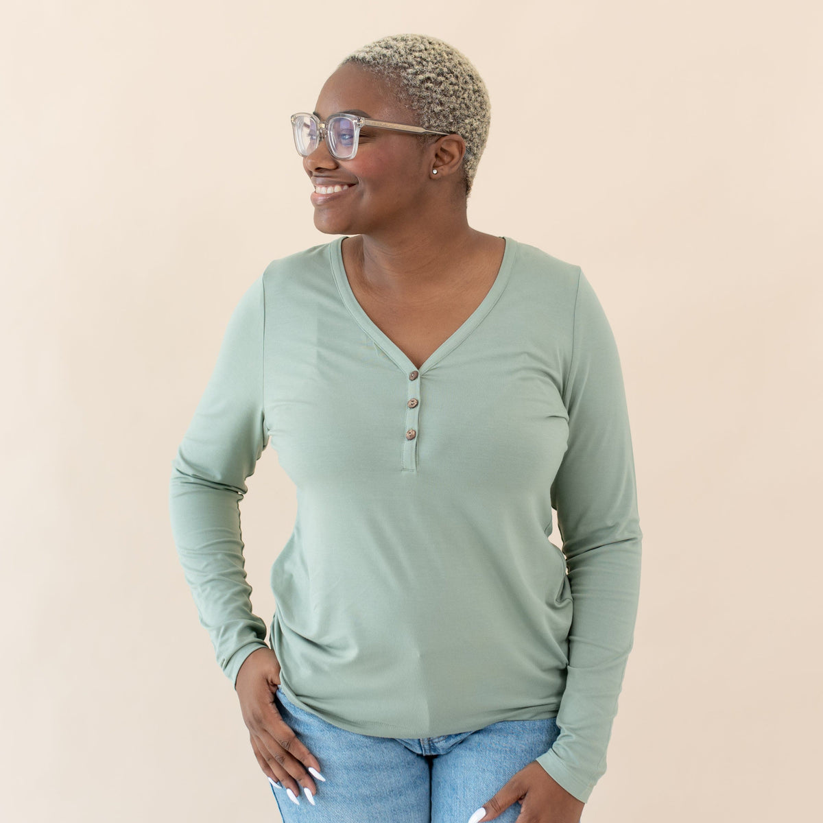 Woman wearing Kyte Baby Women's Bamboo Long Sleeve Henley Tee in Thyme green