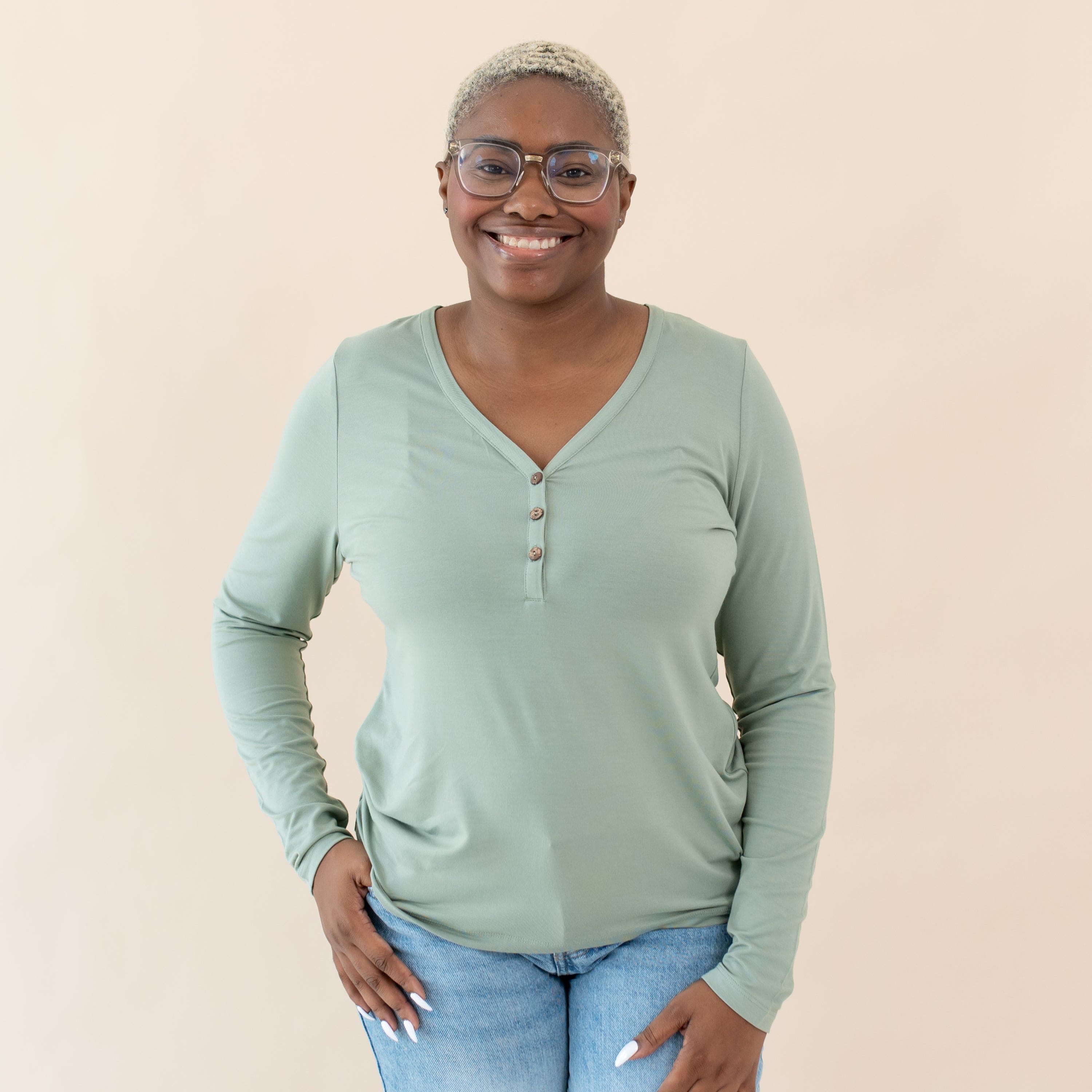 Woman wearing Kyte Baby Women's Long Sleeve Henley Tee in Thyme