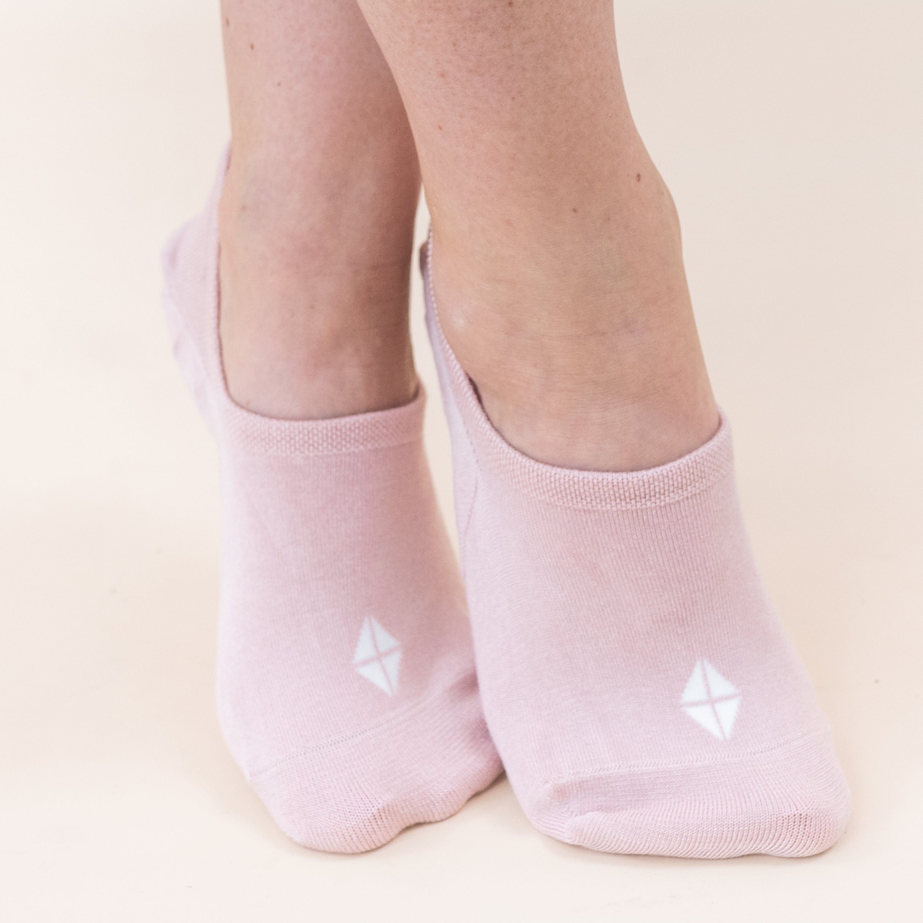 Model wearing Kyte Baby Women's No Show Socks in Neutral Blush Pink