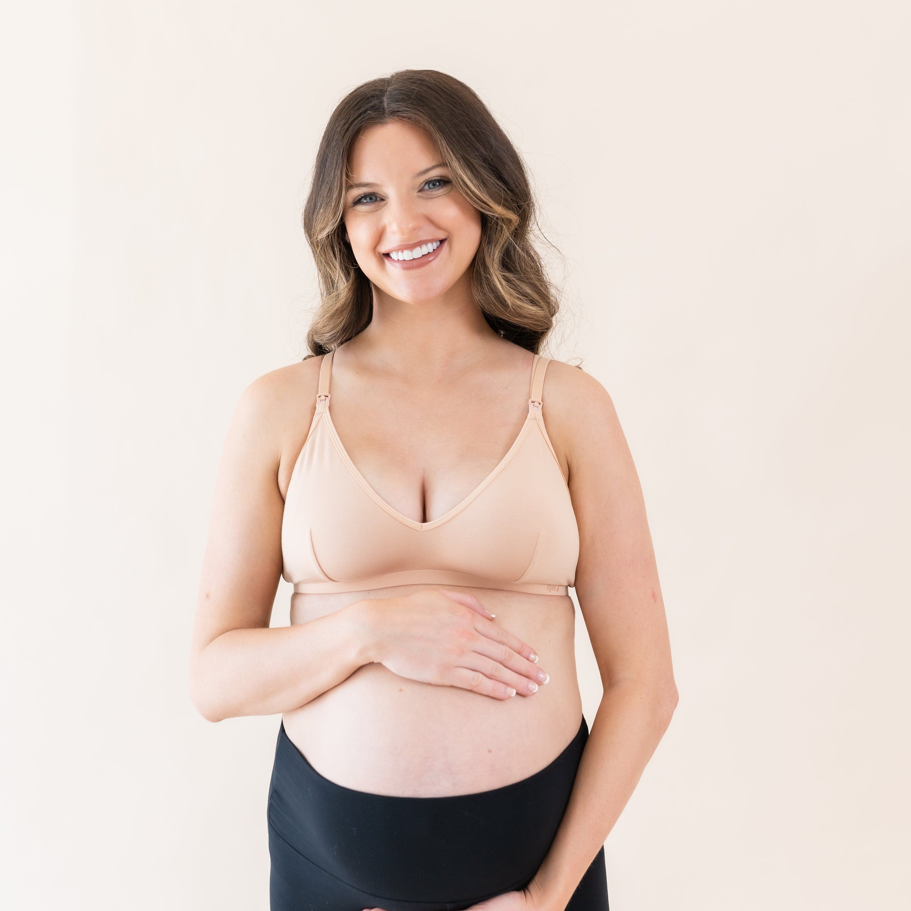 Pregnant woman wearing Kyte Baby Women's Nursing Bra in Chai