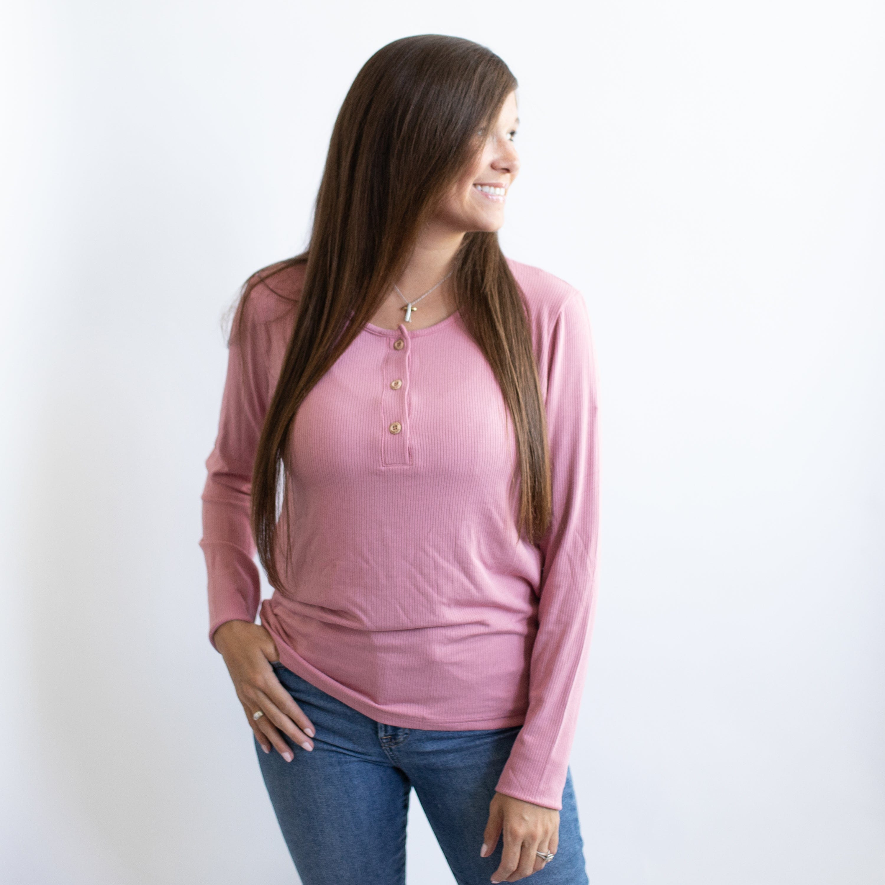 Woman wearing Kyte Baby Women's Ribbed Long Sleeve Henley Top in Apple Blossom pink