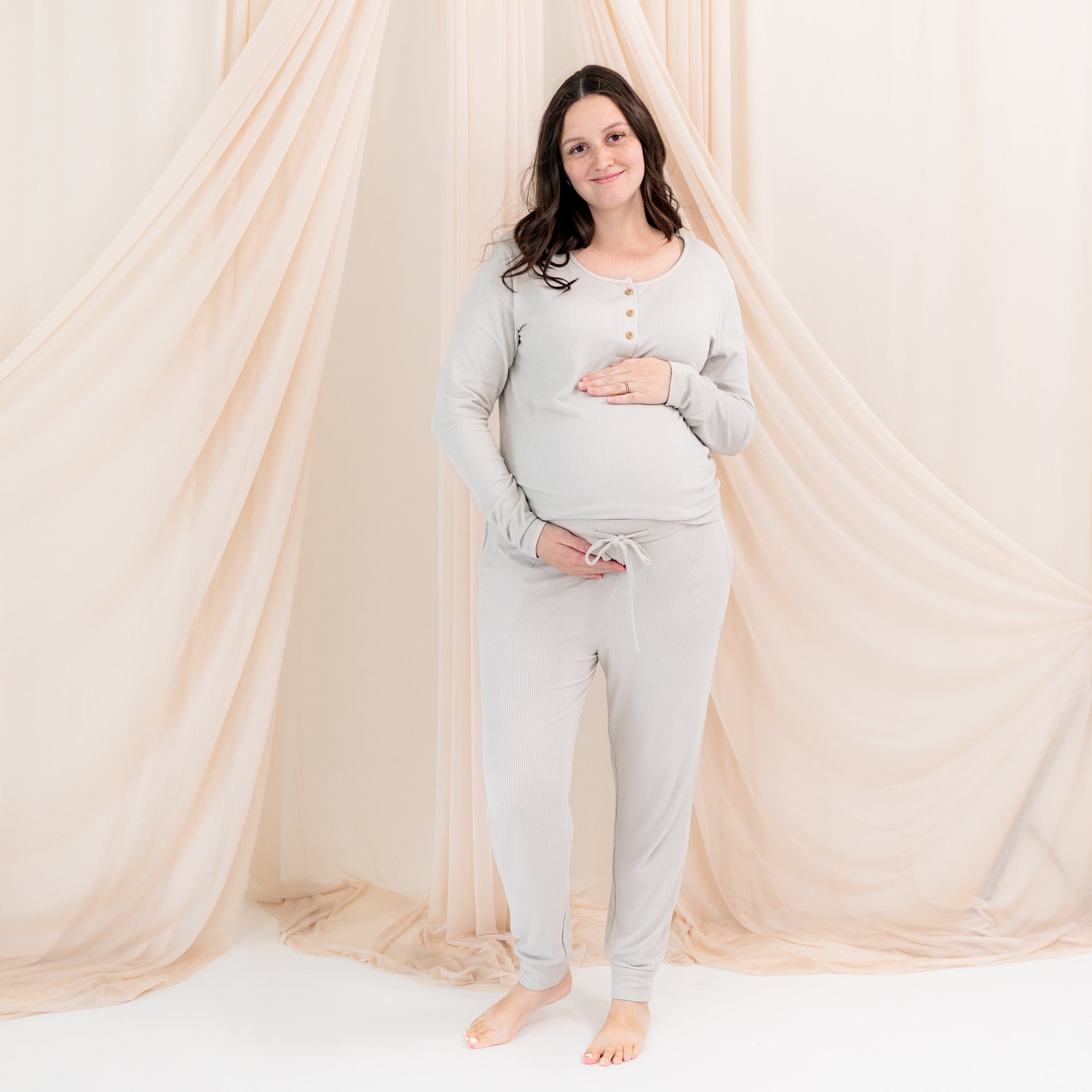 Pregnant woman wearing Kyte Baby Women's Ribbed Jogger Pant in Oat