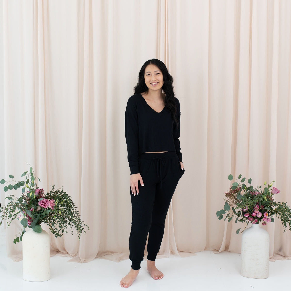 Woman wearing Kyte Baby Women's Ribbed Long Sleeve Crop Top in Midnight