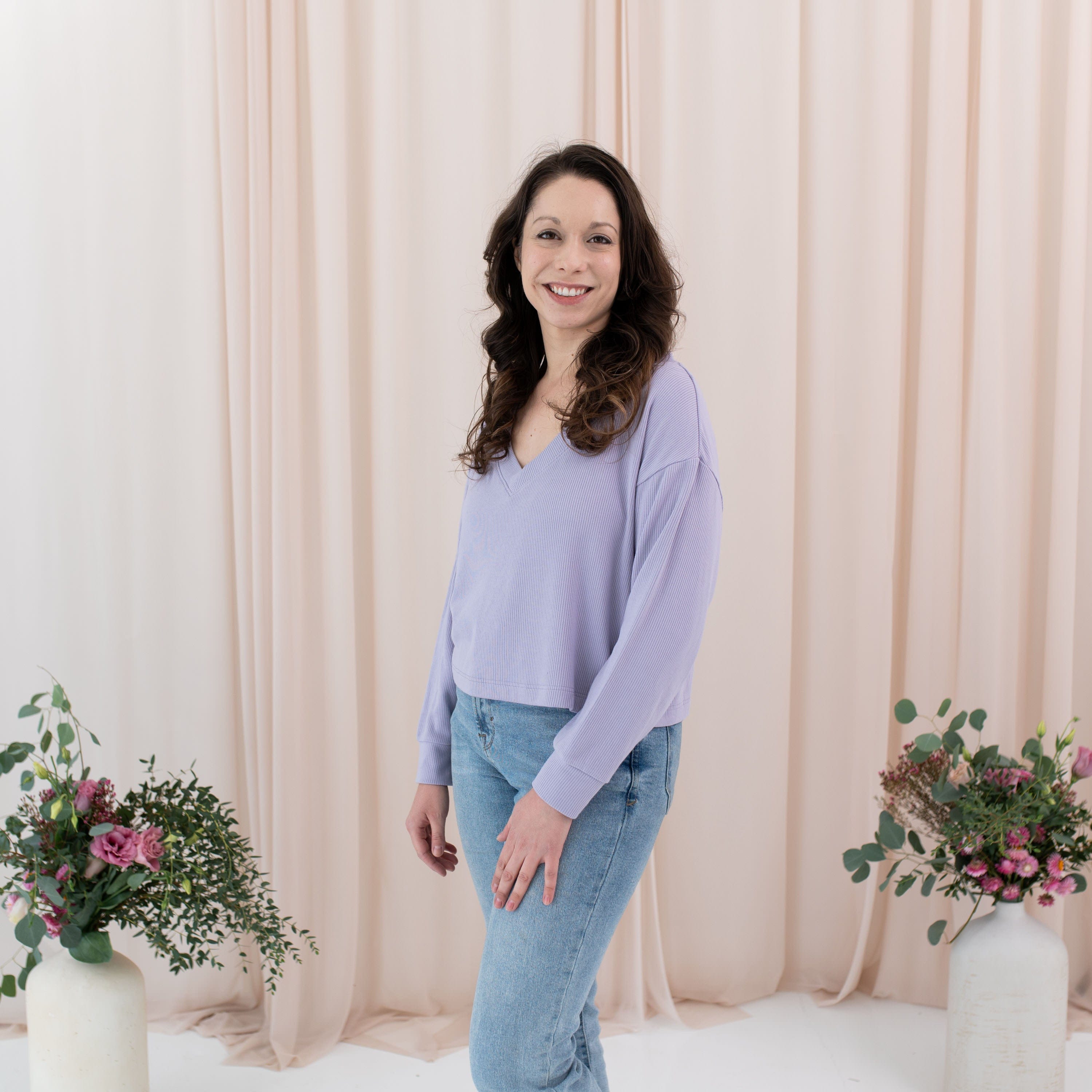 Woman wearing Kyte Baby Ribbed bamboo Long Sleeve Crop Top in Taro