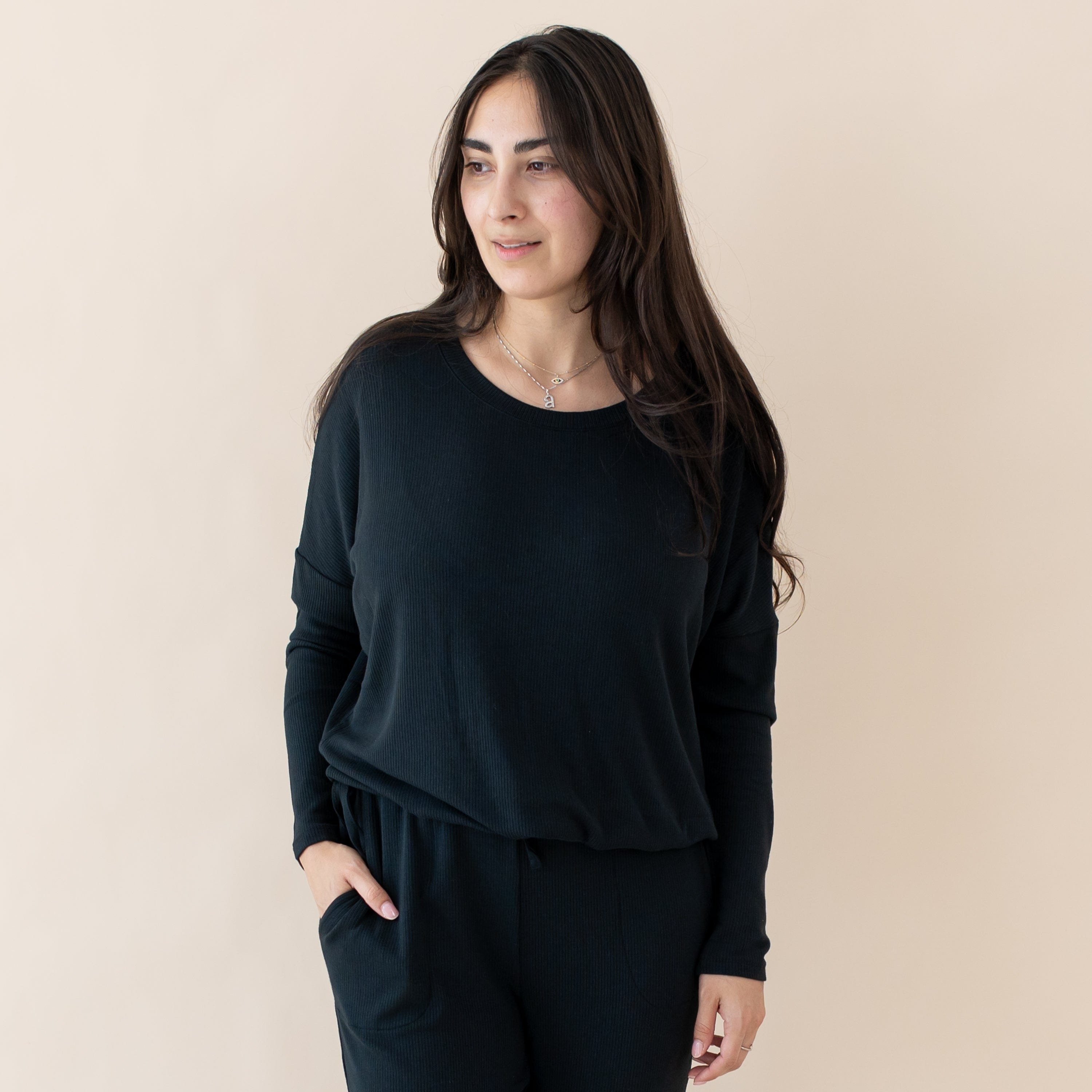 Woman wearing Kyte Baby Women's Ribbed Long Sleeve Drop Shoulder Top in Midnight