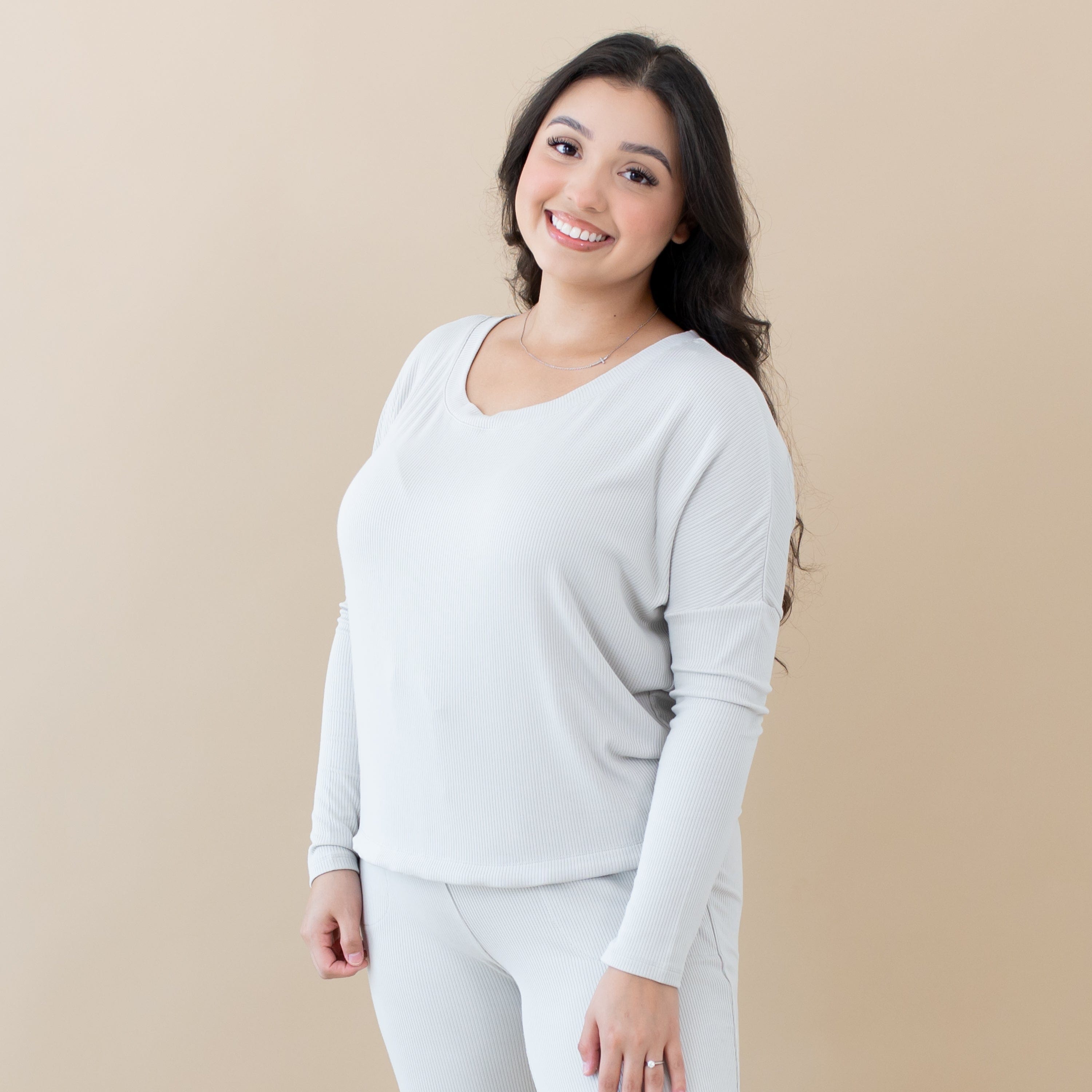 Woman wearing Kyte Baby Women's Ribbed Long Sleeve Drop Shoulder Top in Oat