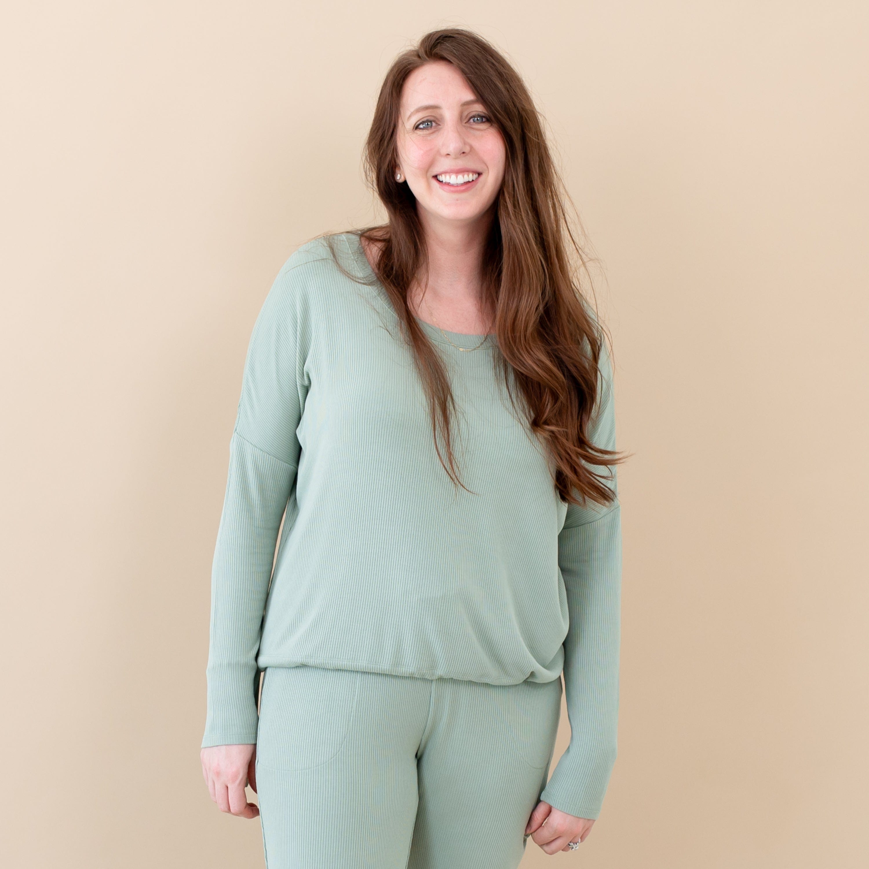 Woman wearing Kyte Baby Women's Ribbed Long Sleeve Drop Shoulder Top in Thyme