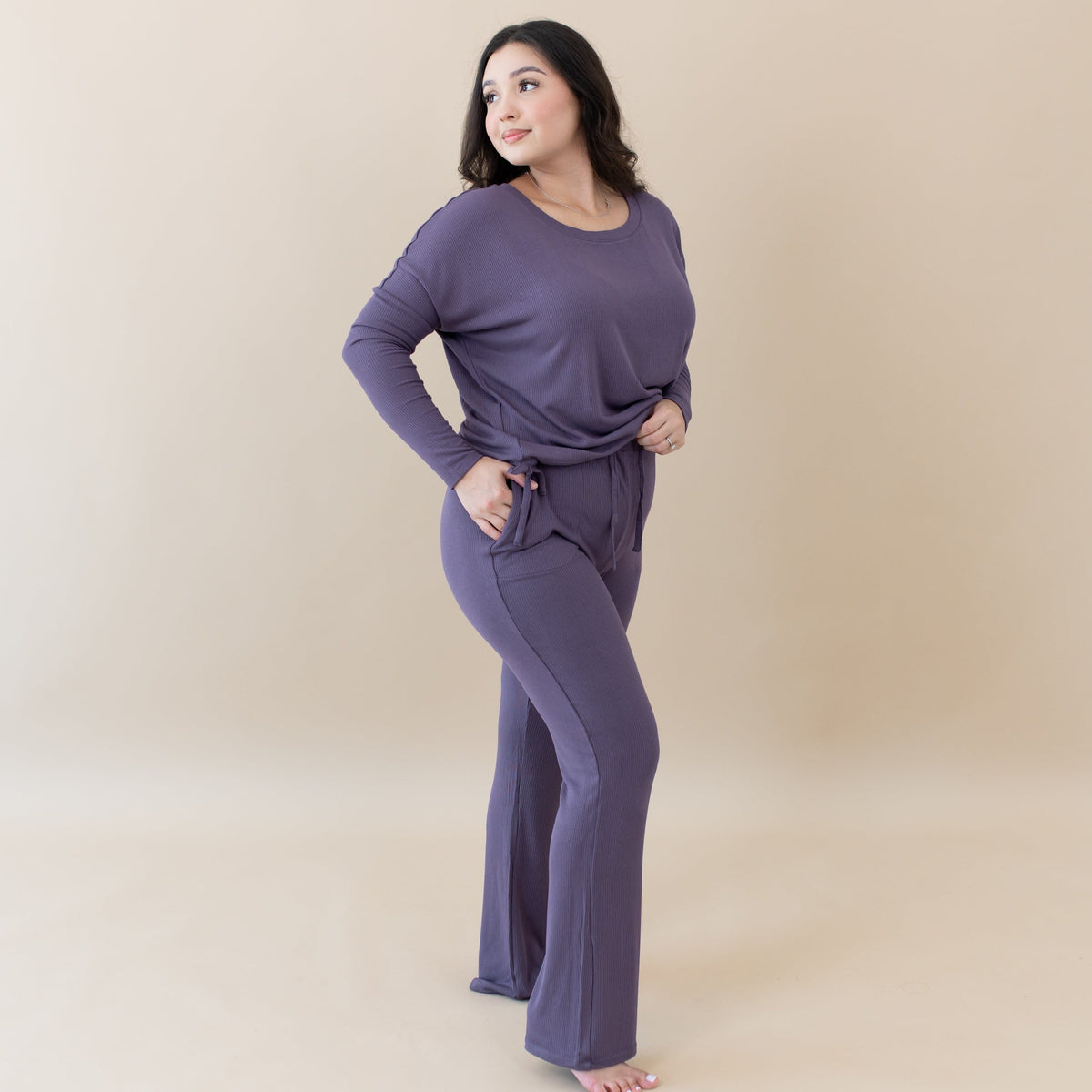 Woman wearing Kyte Baby Women's Ribbed Long Sleeve Drop Shoulder Top and Wide Leg Pant in Currant