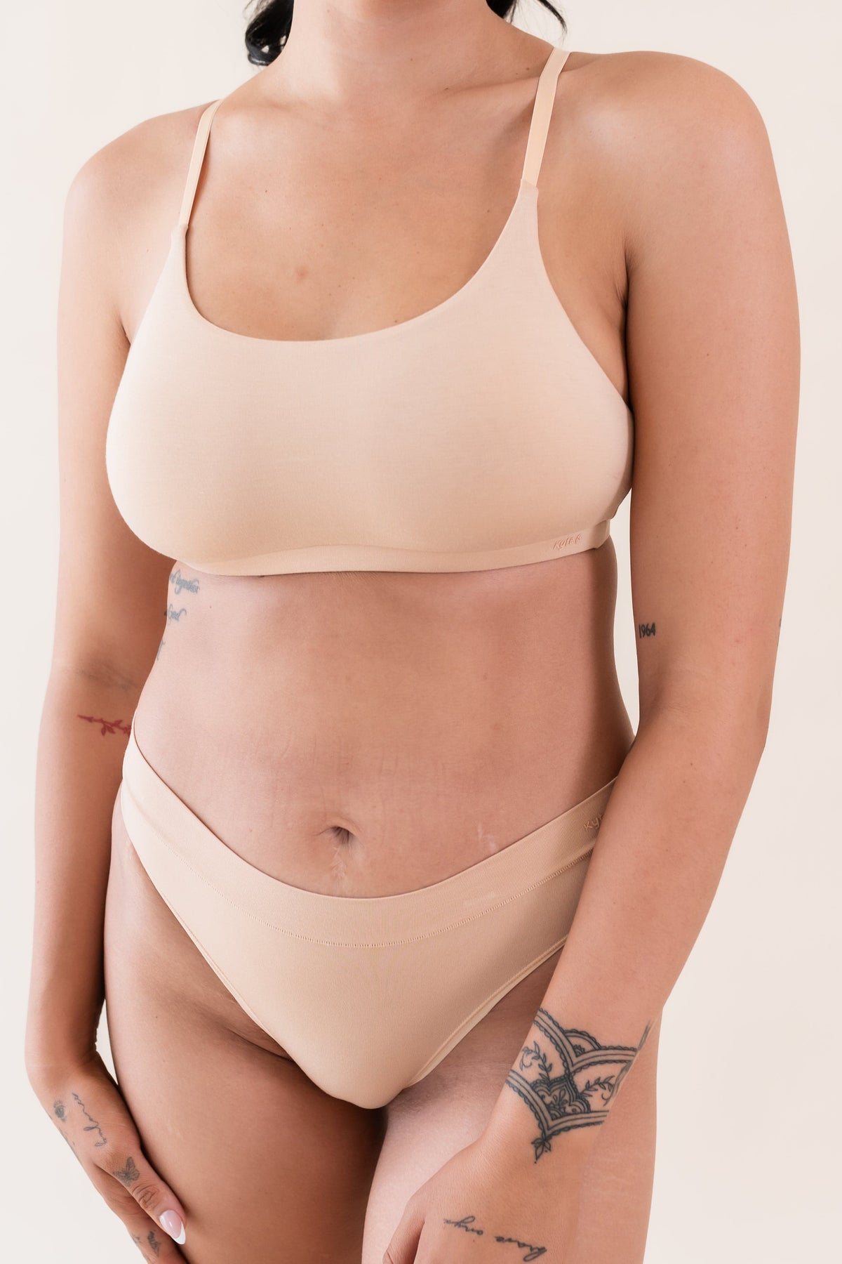 Woman wearing Kyte Baby Women's Scoop Neck Wireless Bra in Chai