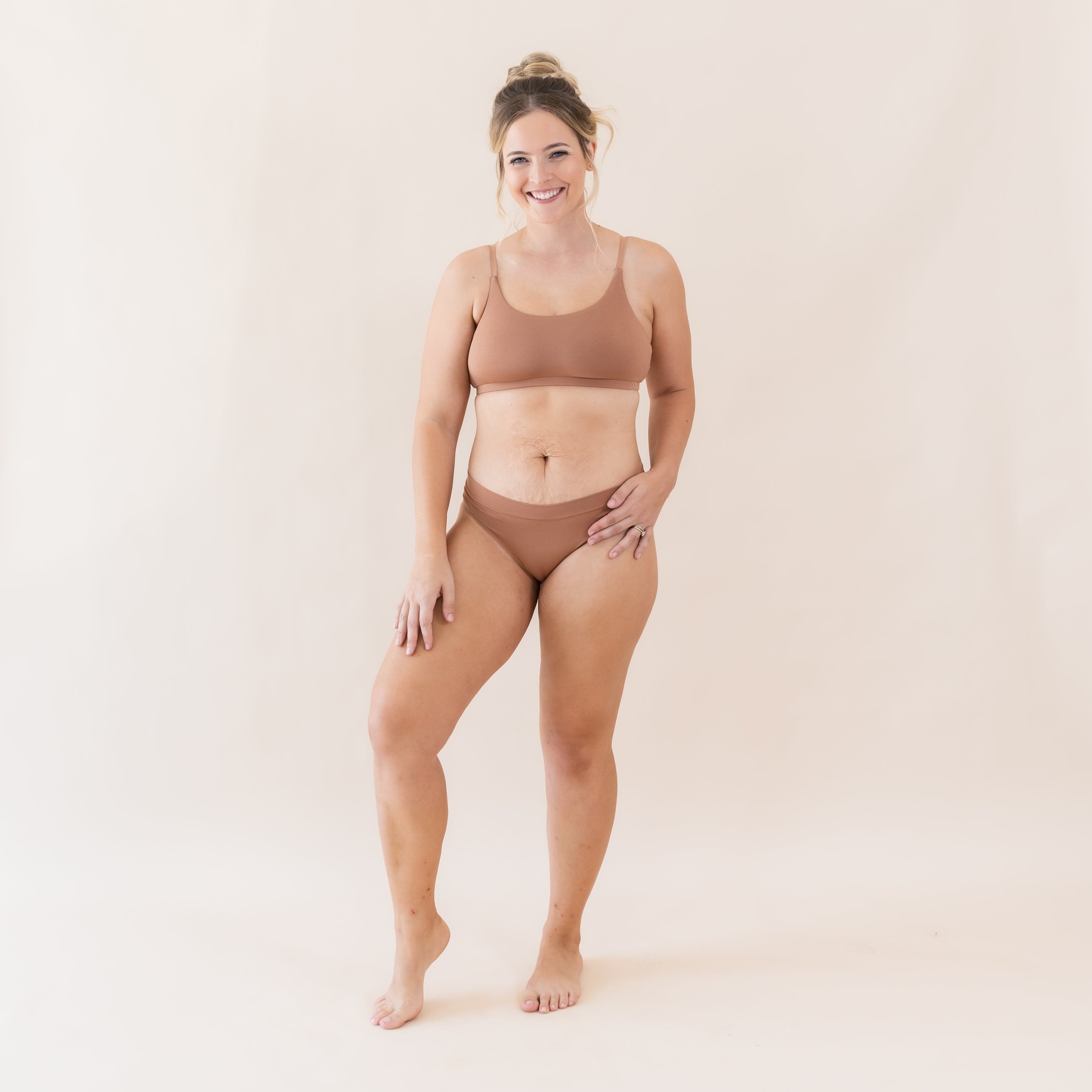Woman wearing Kyte Baby Women's Scoop Neck Bralette and Underwear in Latte