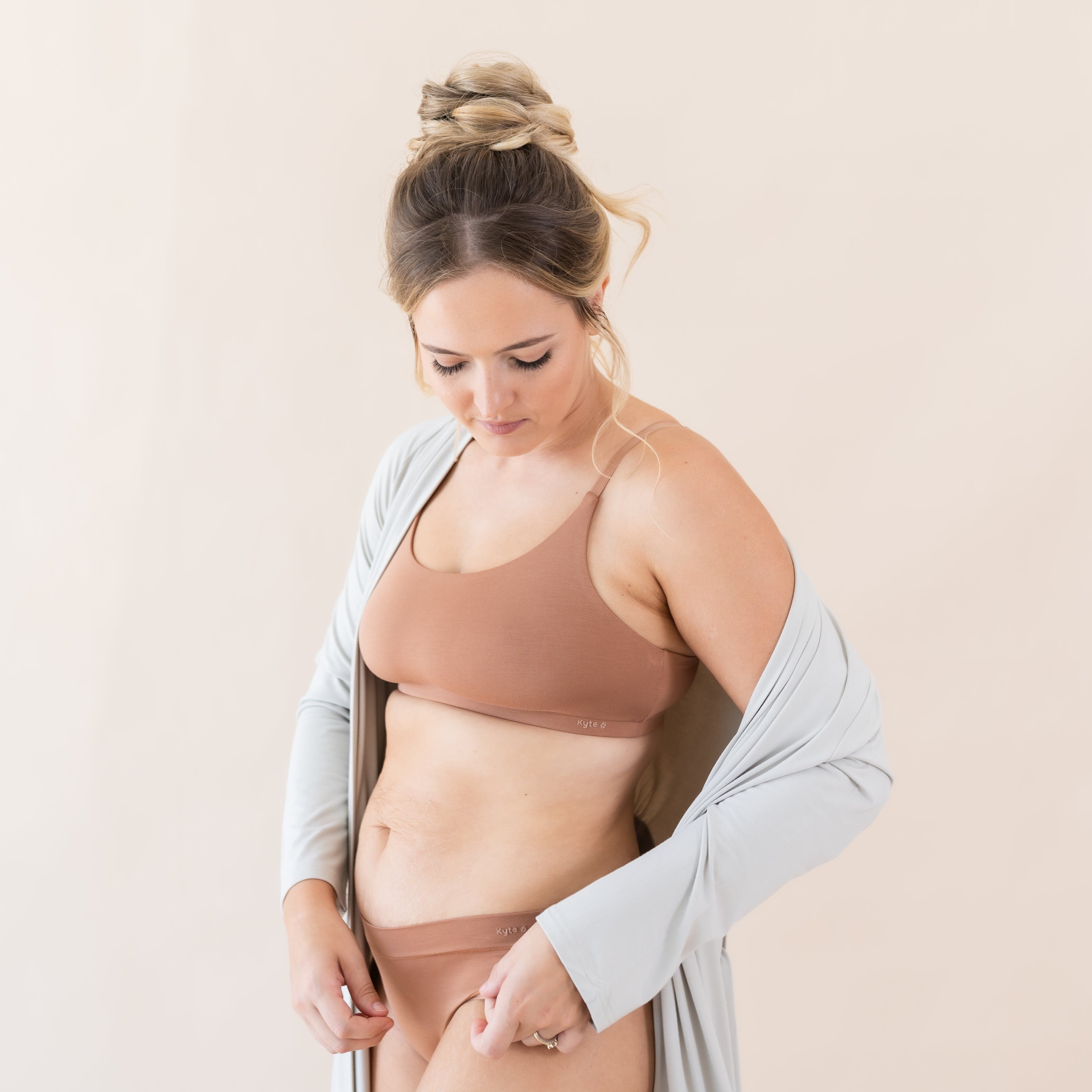 Woman wearing Kyte Baby Women's Scoop Neck Wireless Bra in Latte