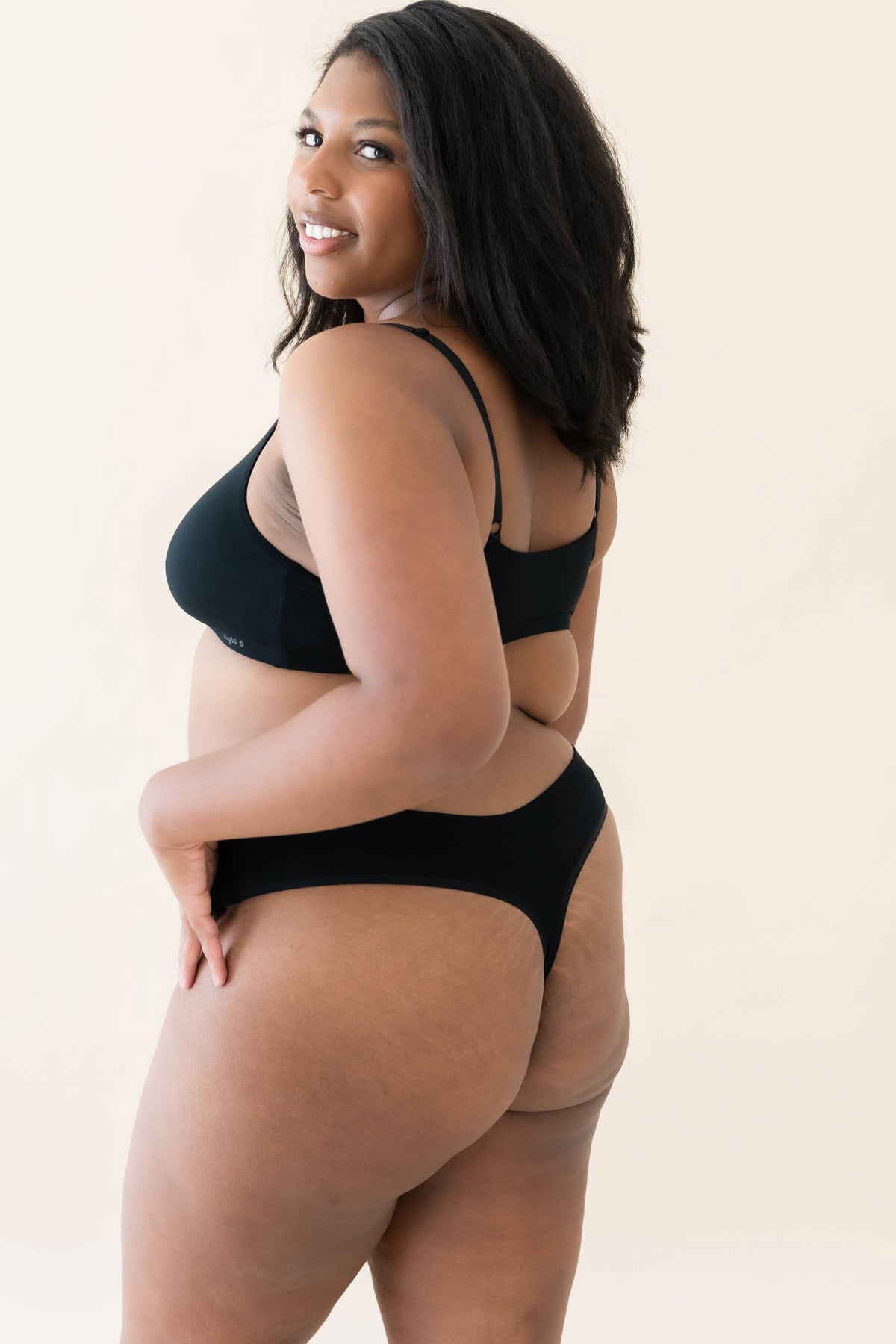 Female modeling the Women's Thong in Midnight with matching bralette