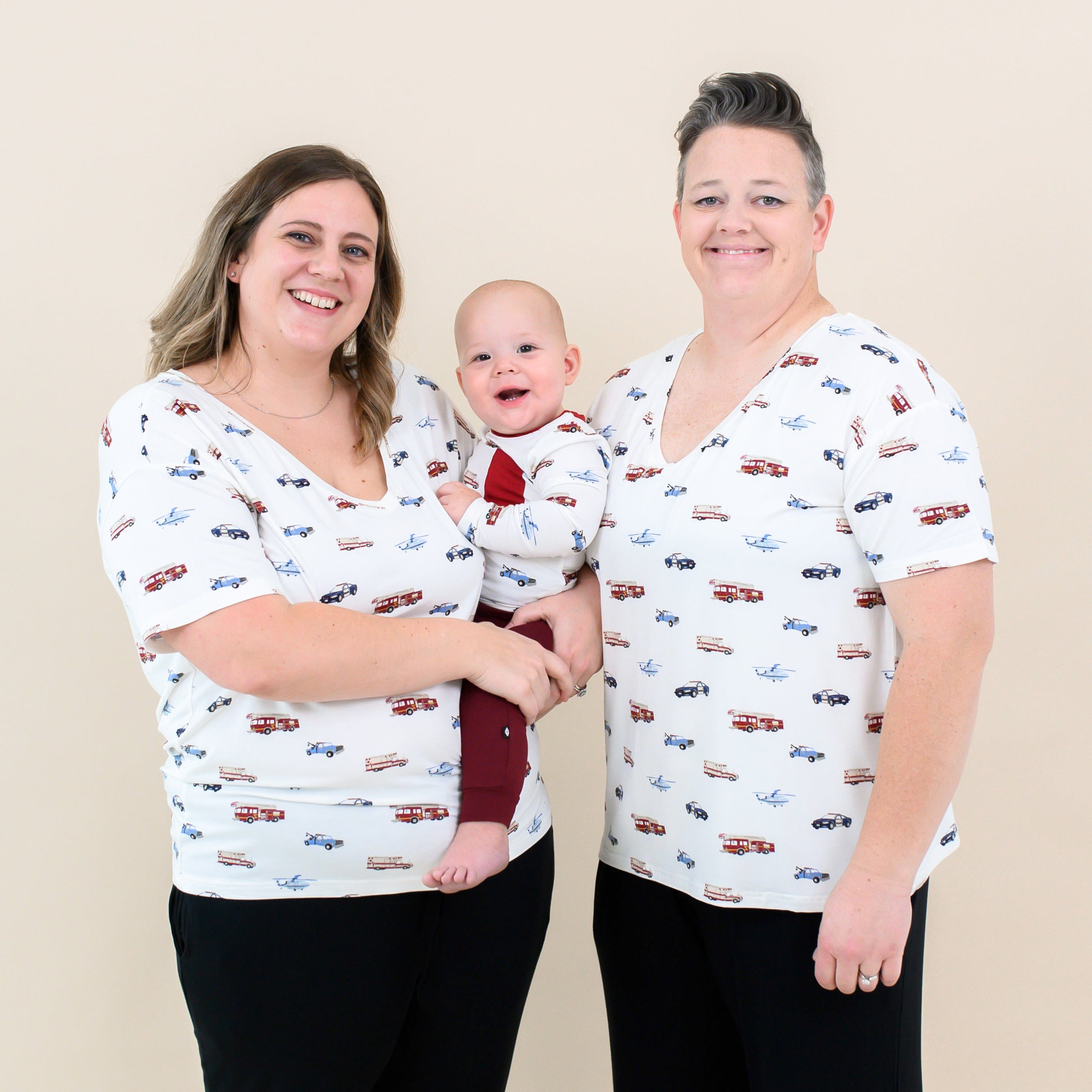 Women wearing Kyte Baby Women's Relaxed Fit V-Neck shirts in First Responder with infant in matching outfit