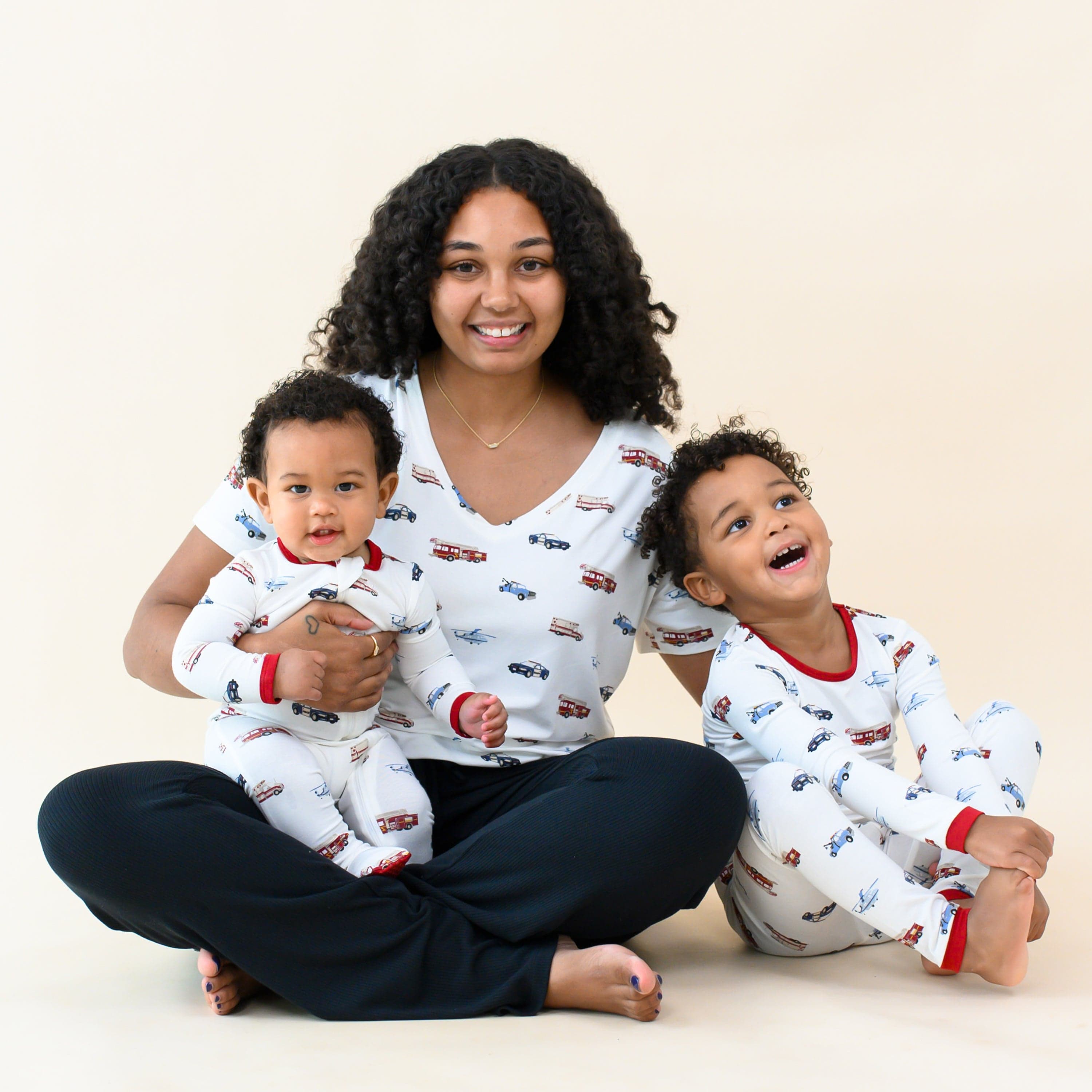 Woman wearing Kyte Baby Women's Relaxed Fit V-Neck in First Responder with children in matching pajamas