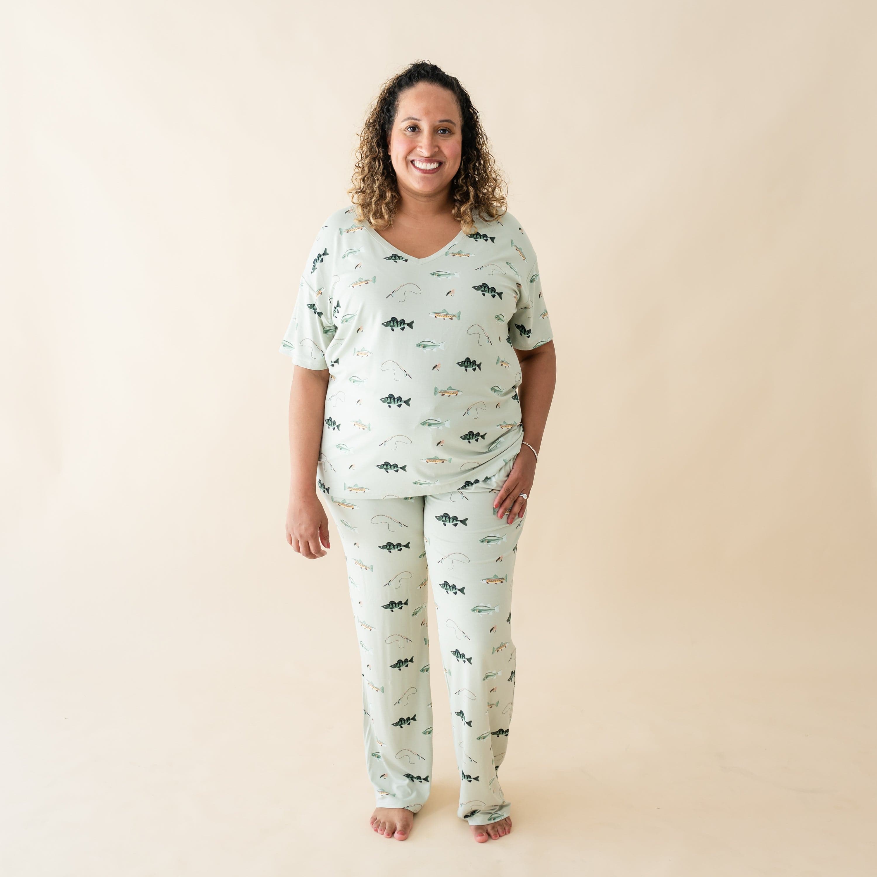 Woman wearing Kyte Baby Women's Relaxed Fit V-Neck tee and pants in Fishing