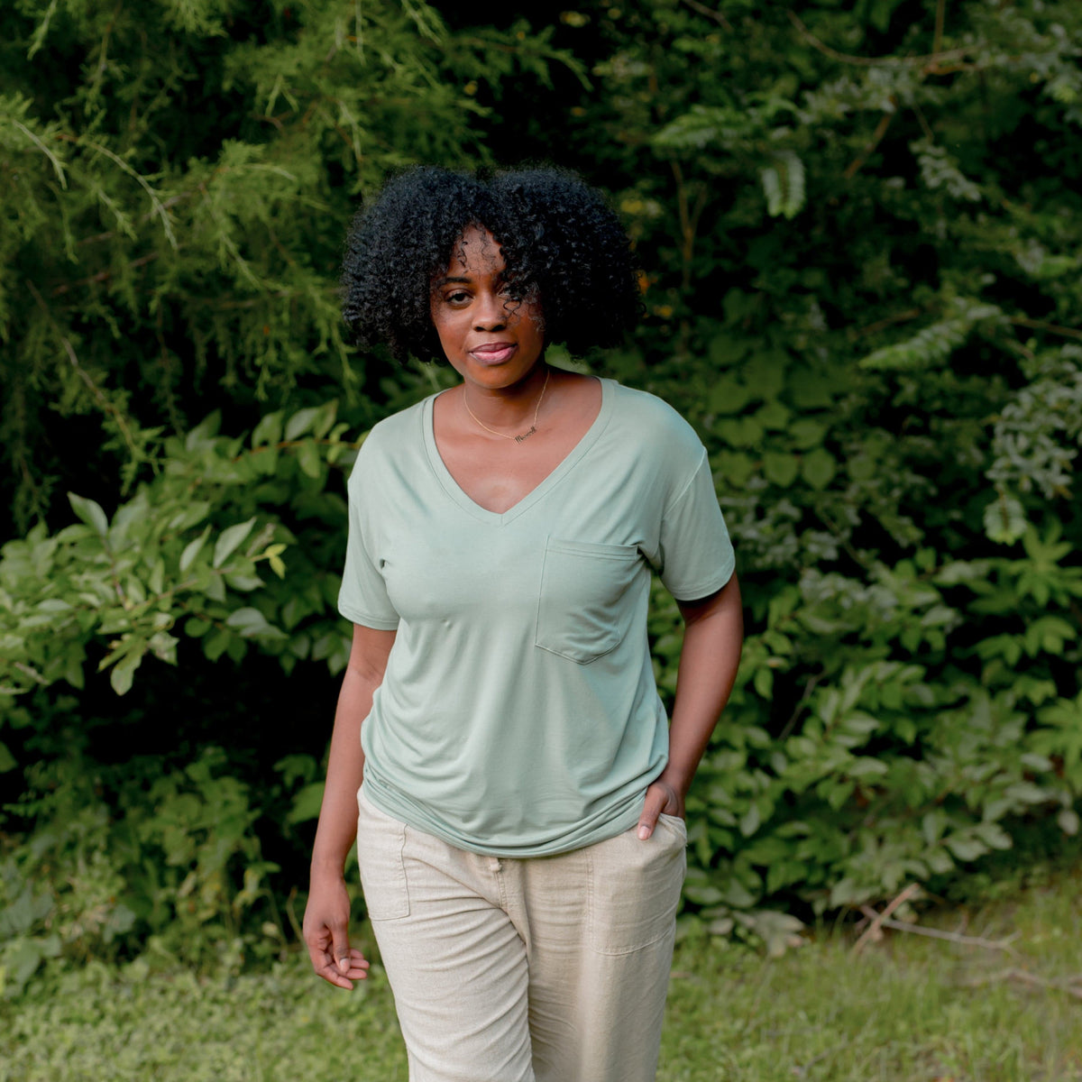 Woman wearing Kyte Baby Women's Relaxed Fit V-Neck in Thyme
