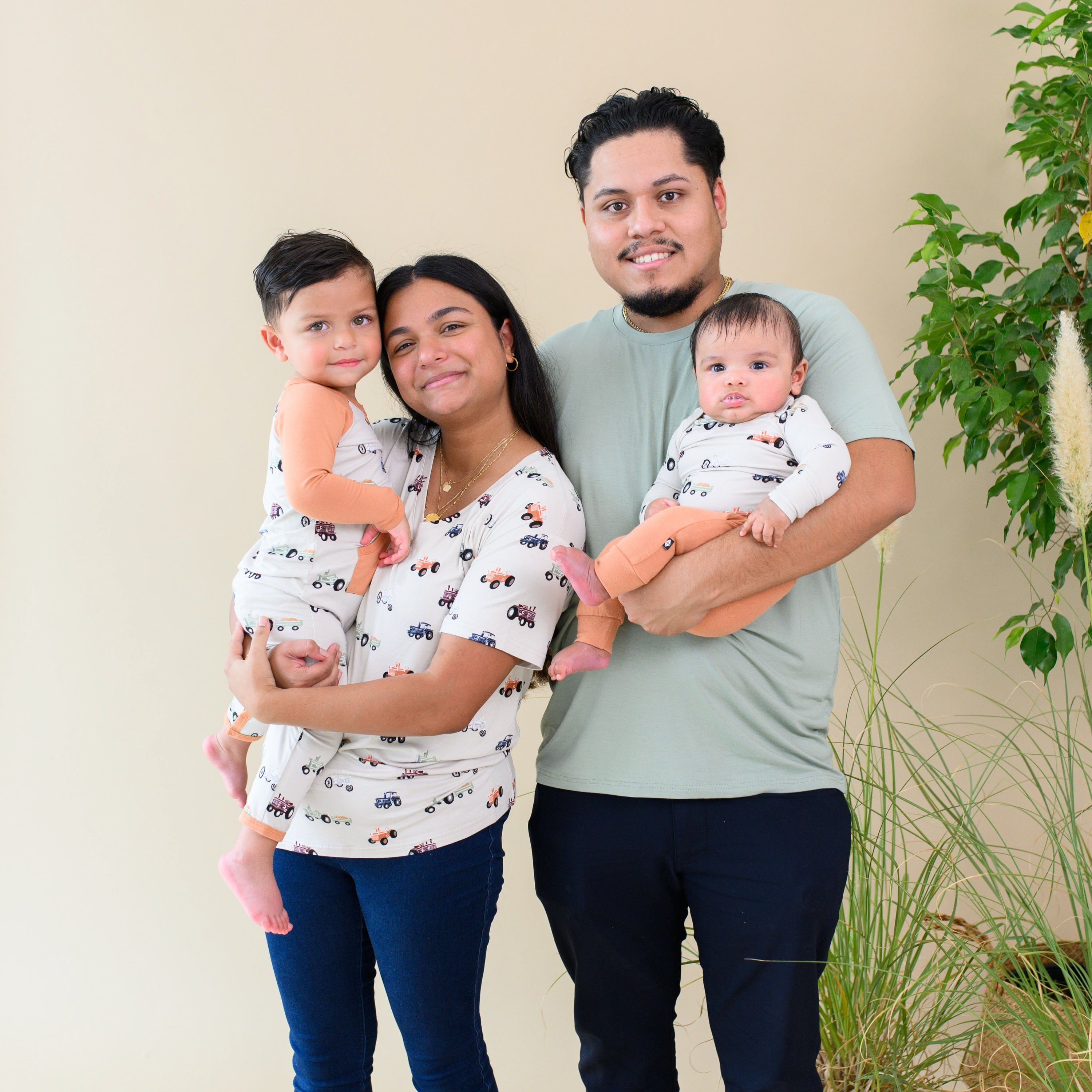 Mom wearing Kyte Baby Women's Relaxed Fit V-Neck in Tractor with family in matching outfits