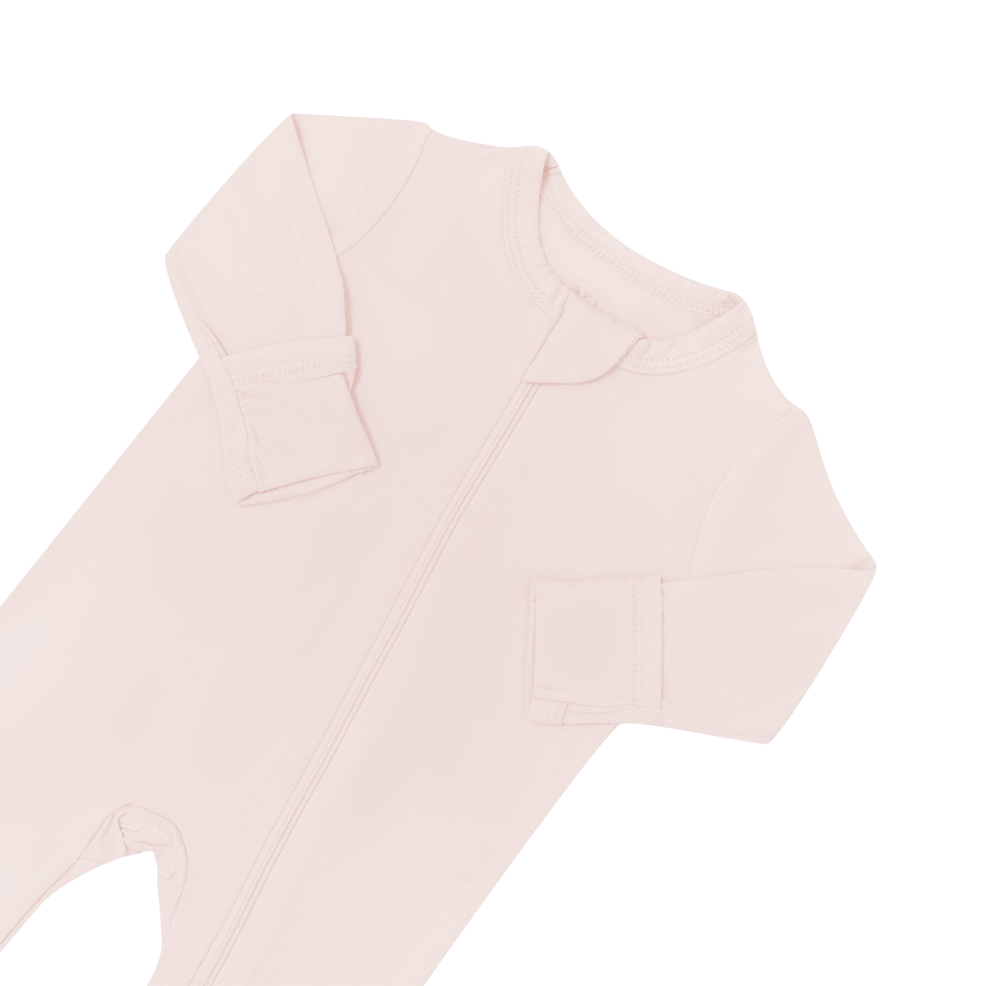 Fold over cuffs and zipper garage on Kyte Baby Zippered Footie in Blush