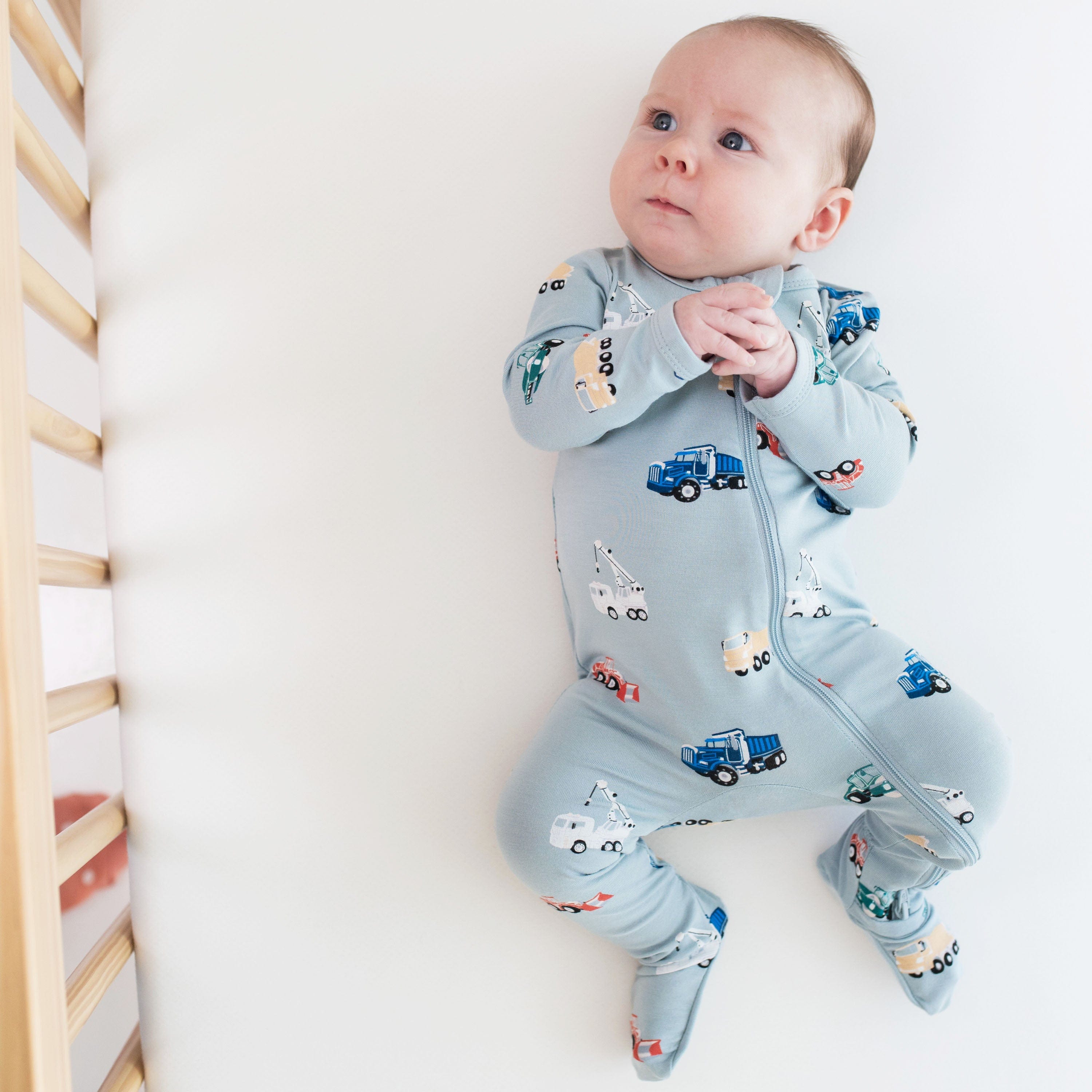 Infant wearing Kyte Baby breathable bamboo Zippered Footie in Construction