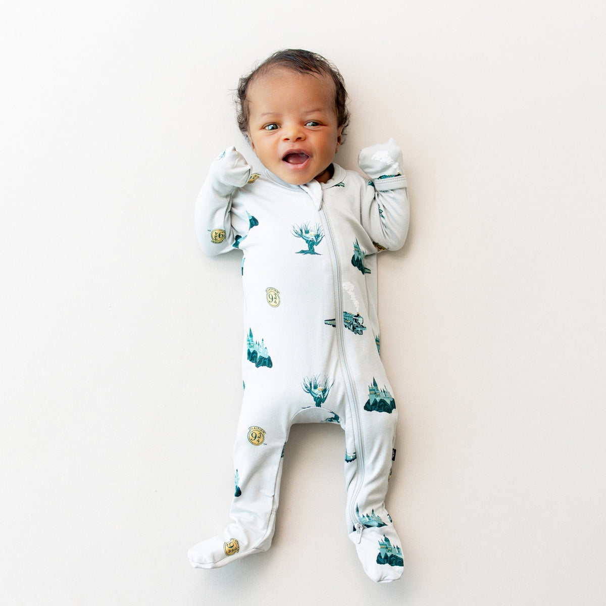 Infant modeling the Zippered Footie Harry Potter pajamas in Journey with the fold over cuffs